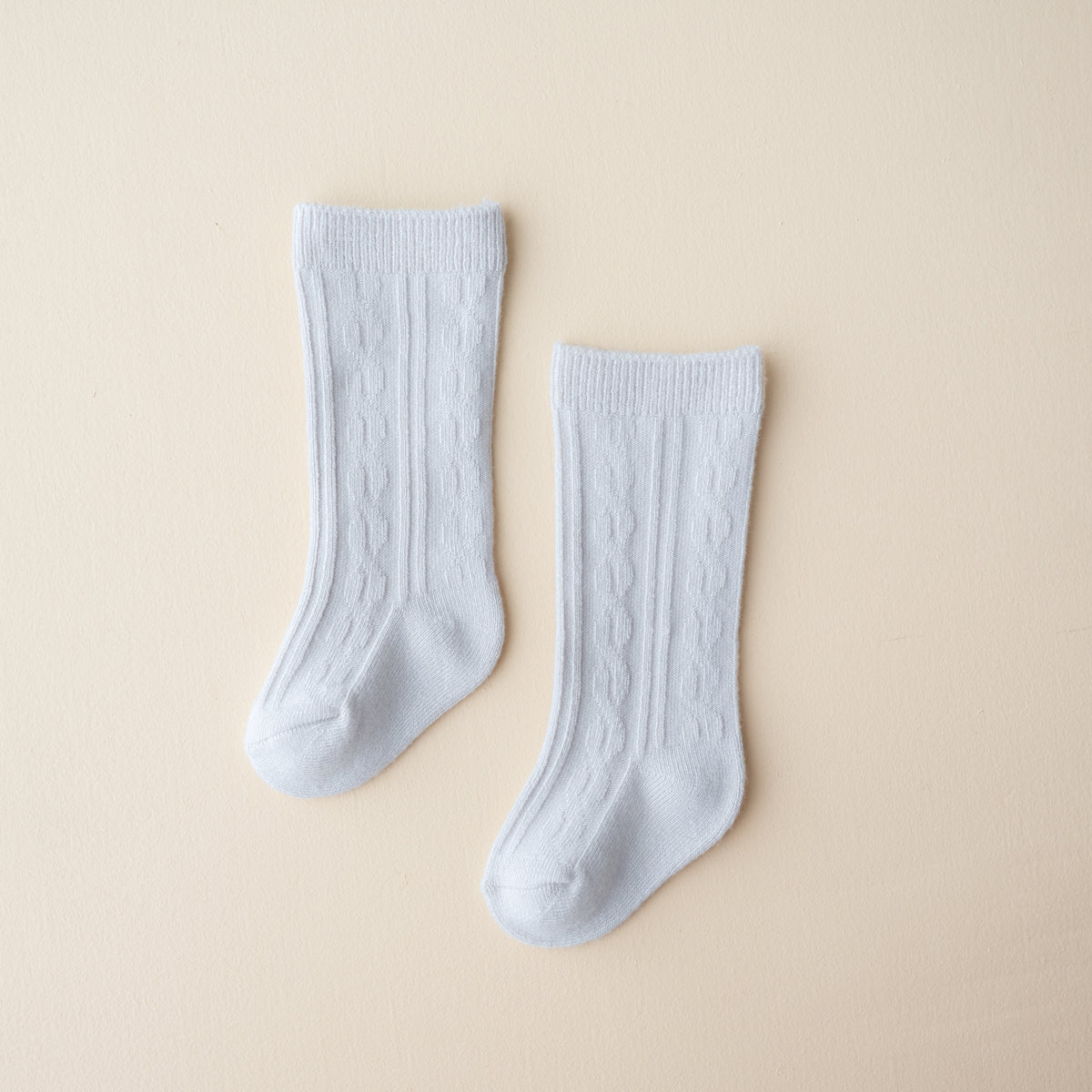 Knee High Socks in Storm shown laid out on a light neutral backdrop
