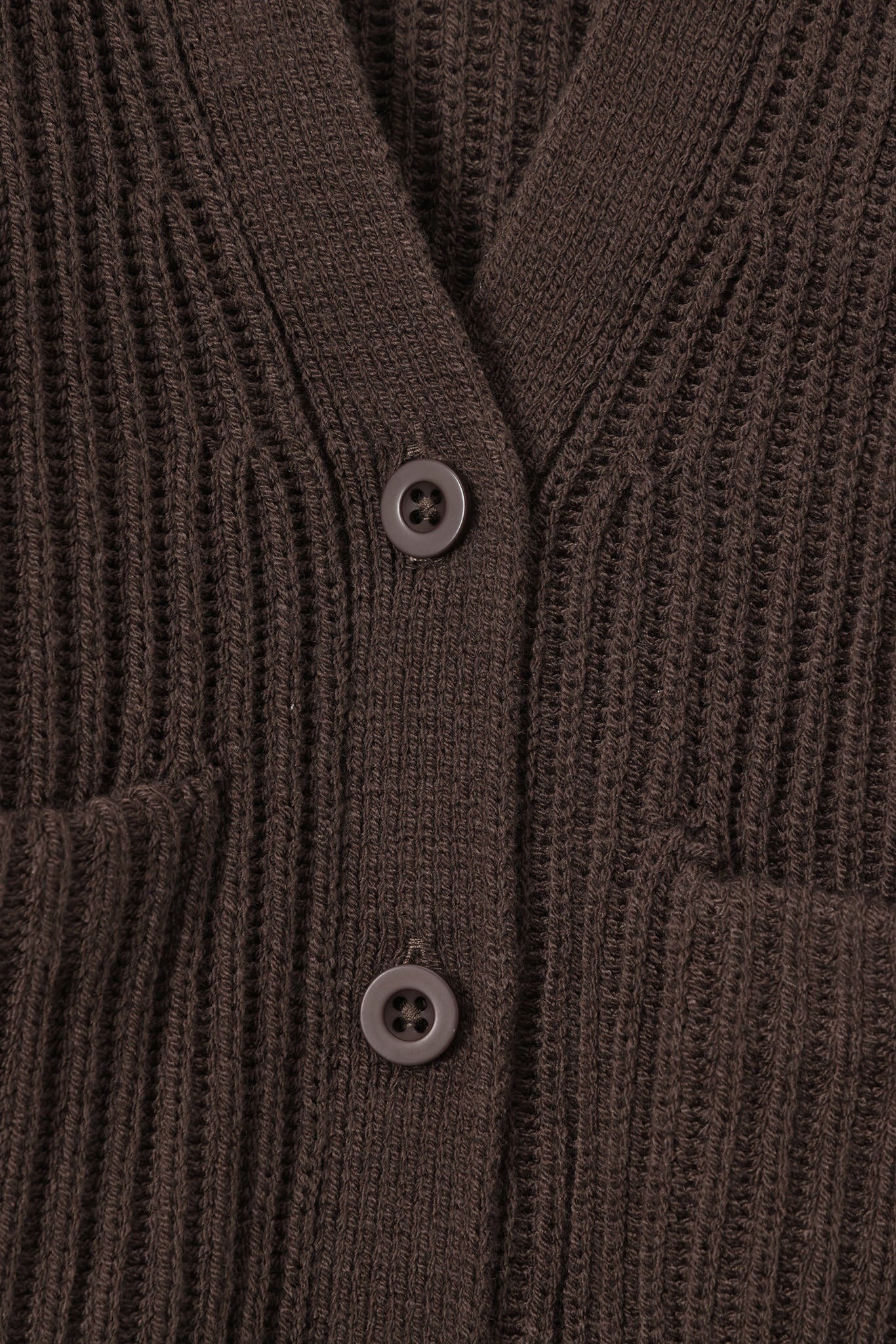 Close up of oversized dark brown cardigan with button closure