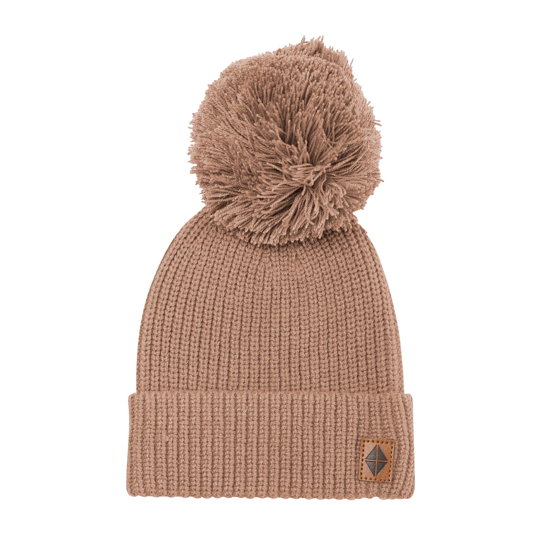 Product photo of the Chunky Knit Pom Beanie in Latte with the Kyte Baby vegan leather tag visible