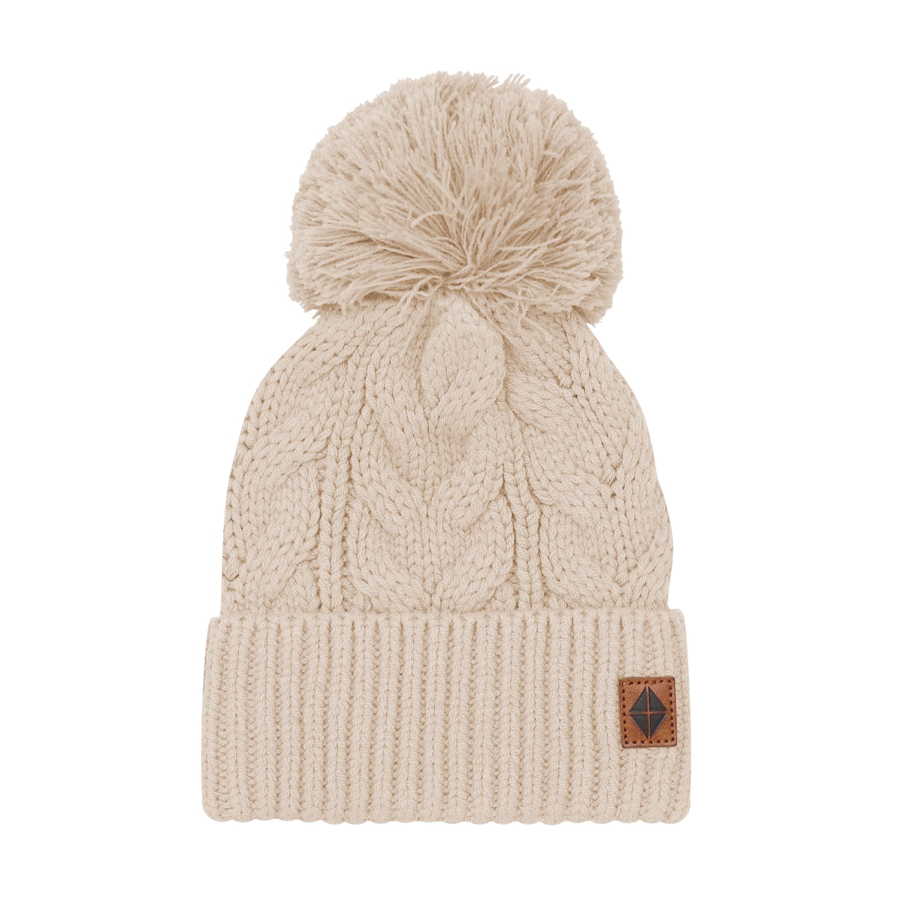 Product photo of the Chunky Cable Knit Beanie in Almond with the Kyte Baby Vegan leather tag visible