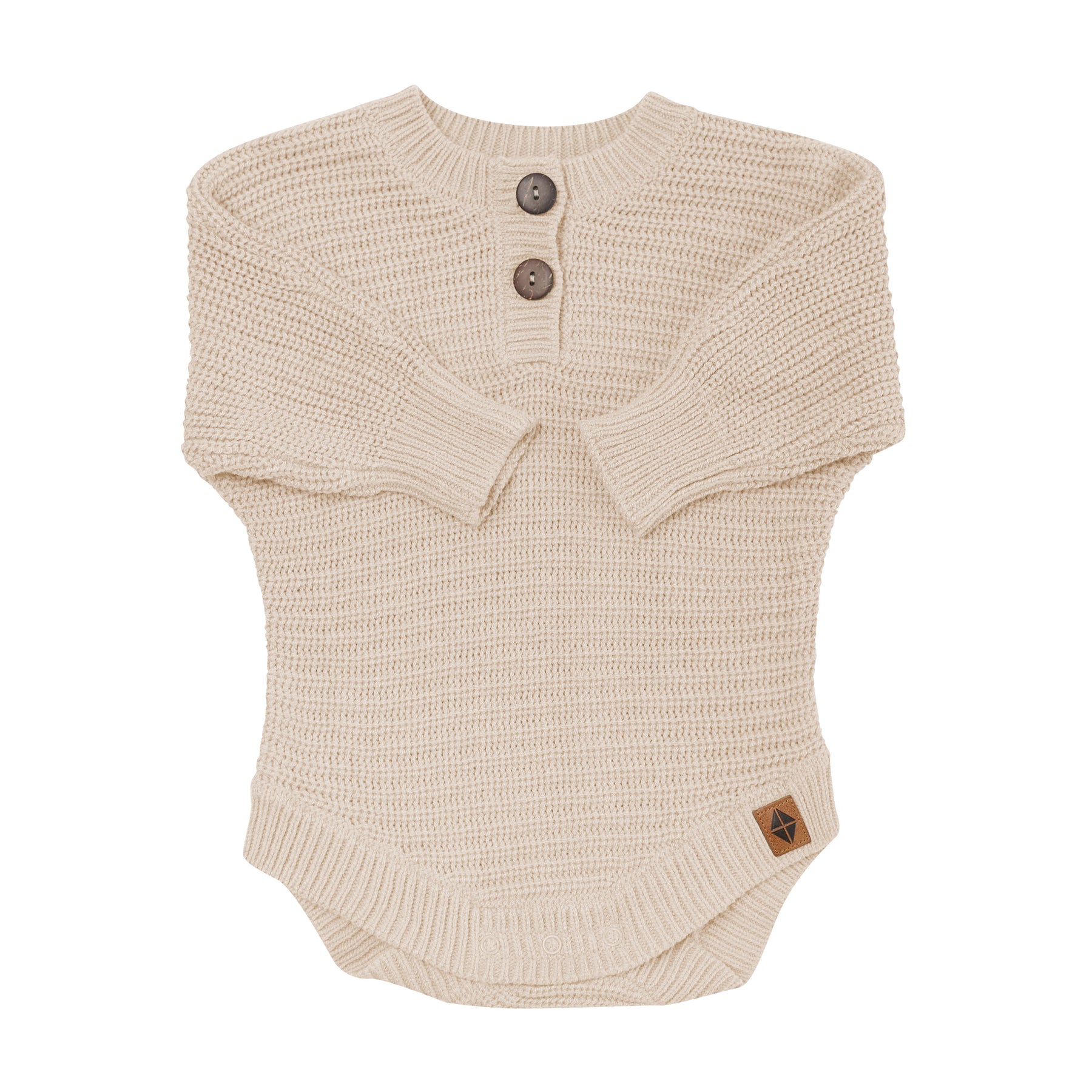 Chunky Knit Romper in Almond shown with the arms folded inwards