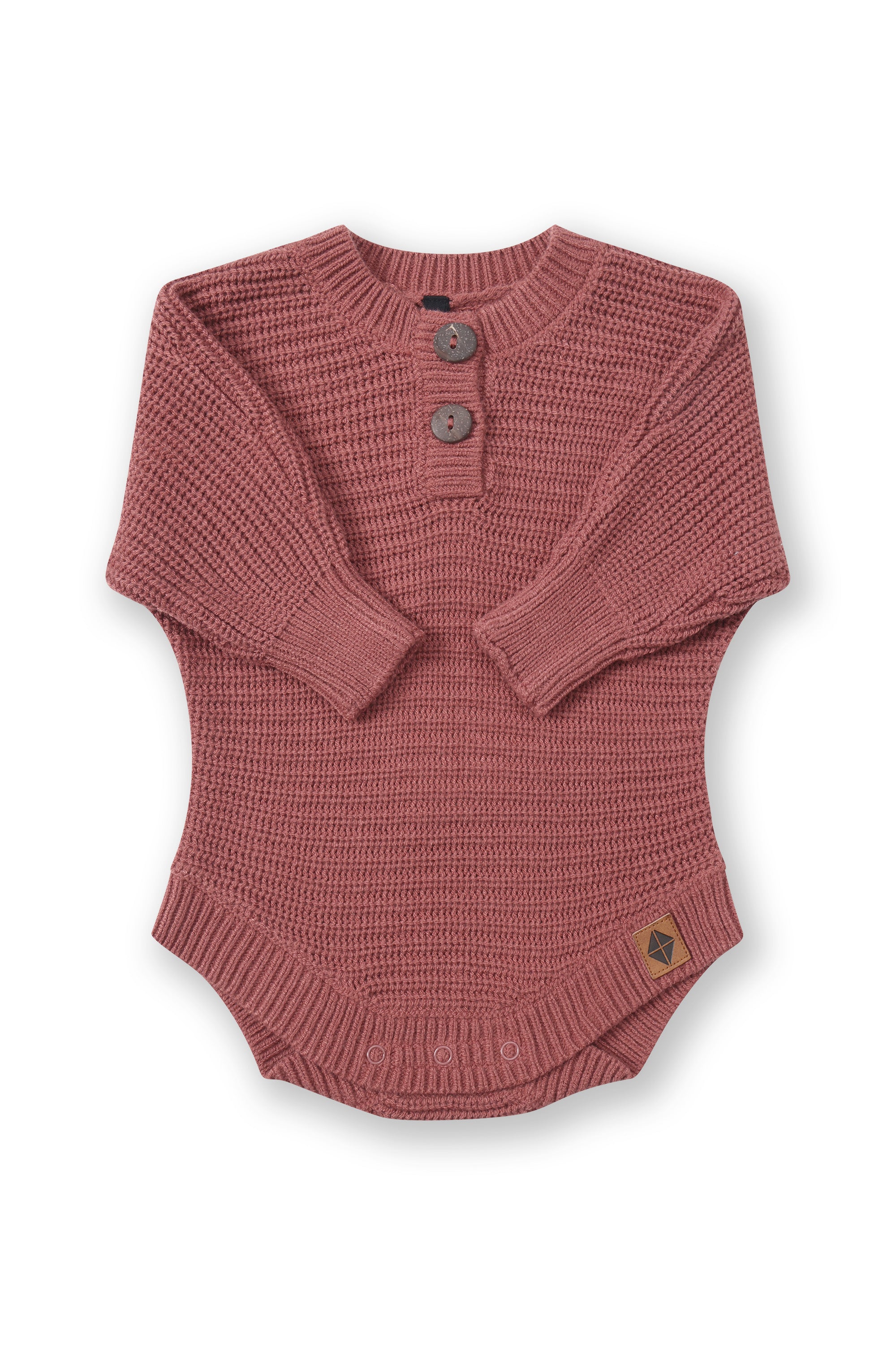 Chunky Knit Romper in Ember with folded sleeves on a white background