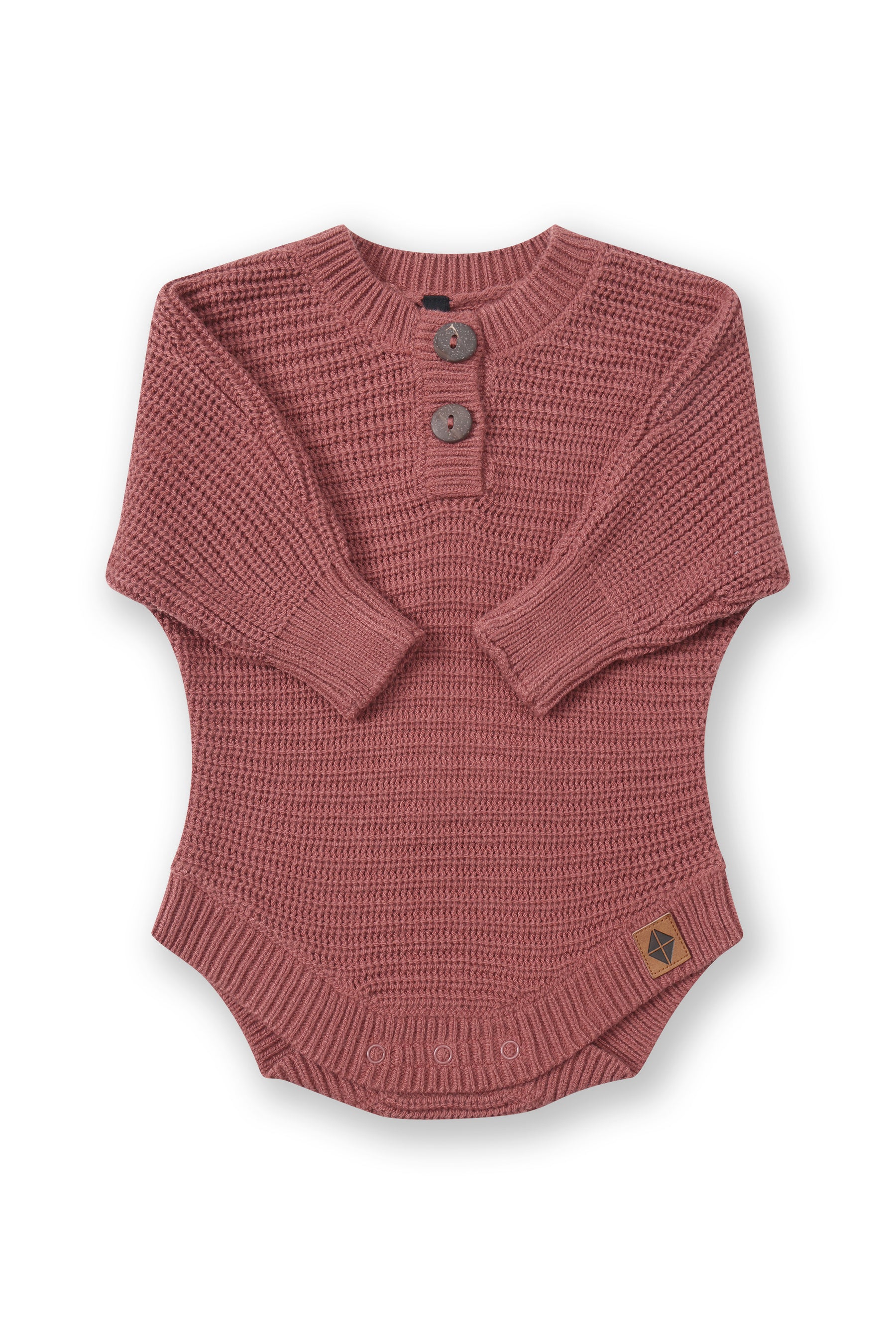 Chunky Knit Romper in Ember with folded sleeves on a white background