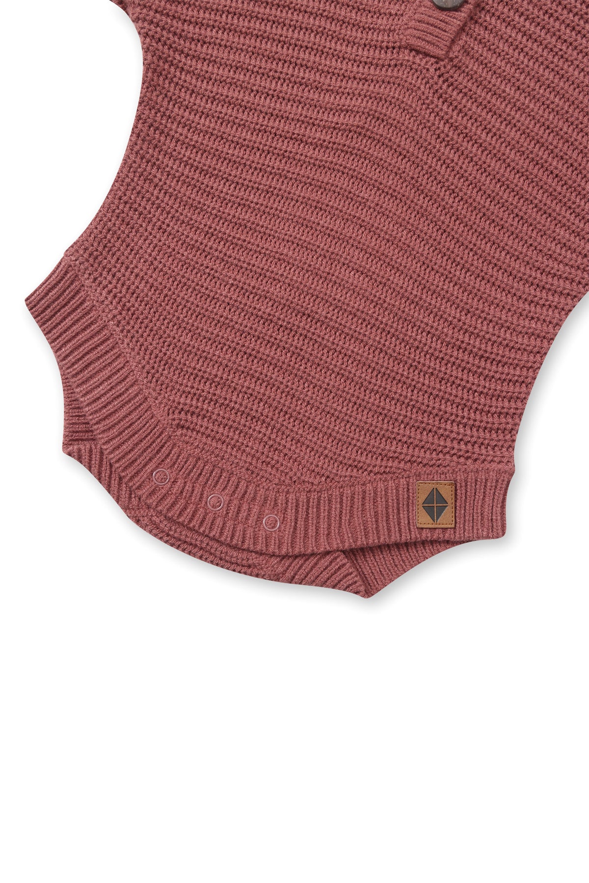 Bottom part of Chunky Knit Romper in Ember with snap buttons on a white background
