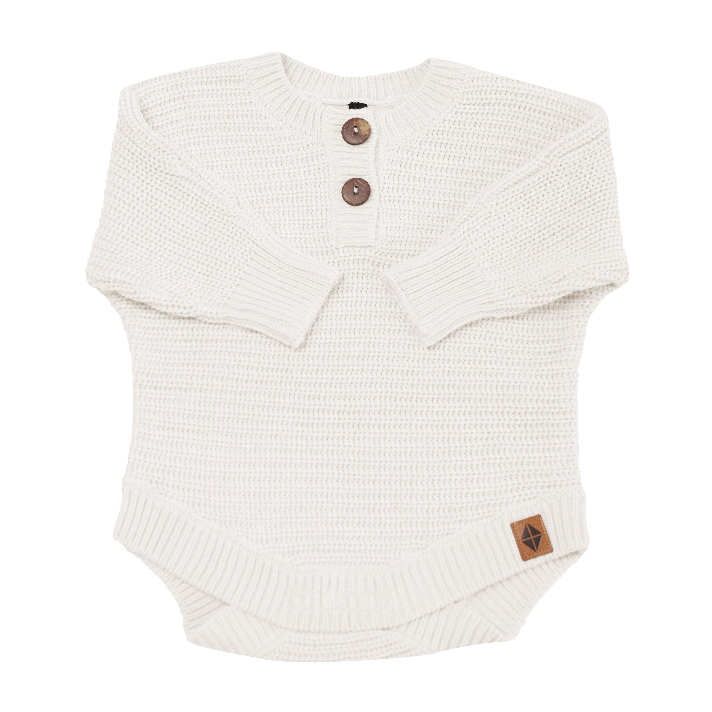 Chunky Knit Romper in Oat shown with arms folded inwards
