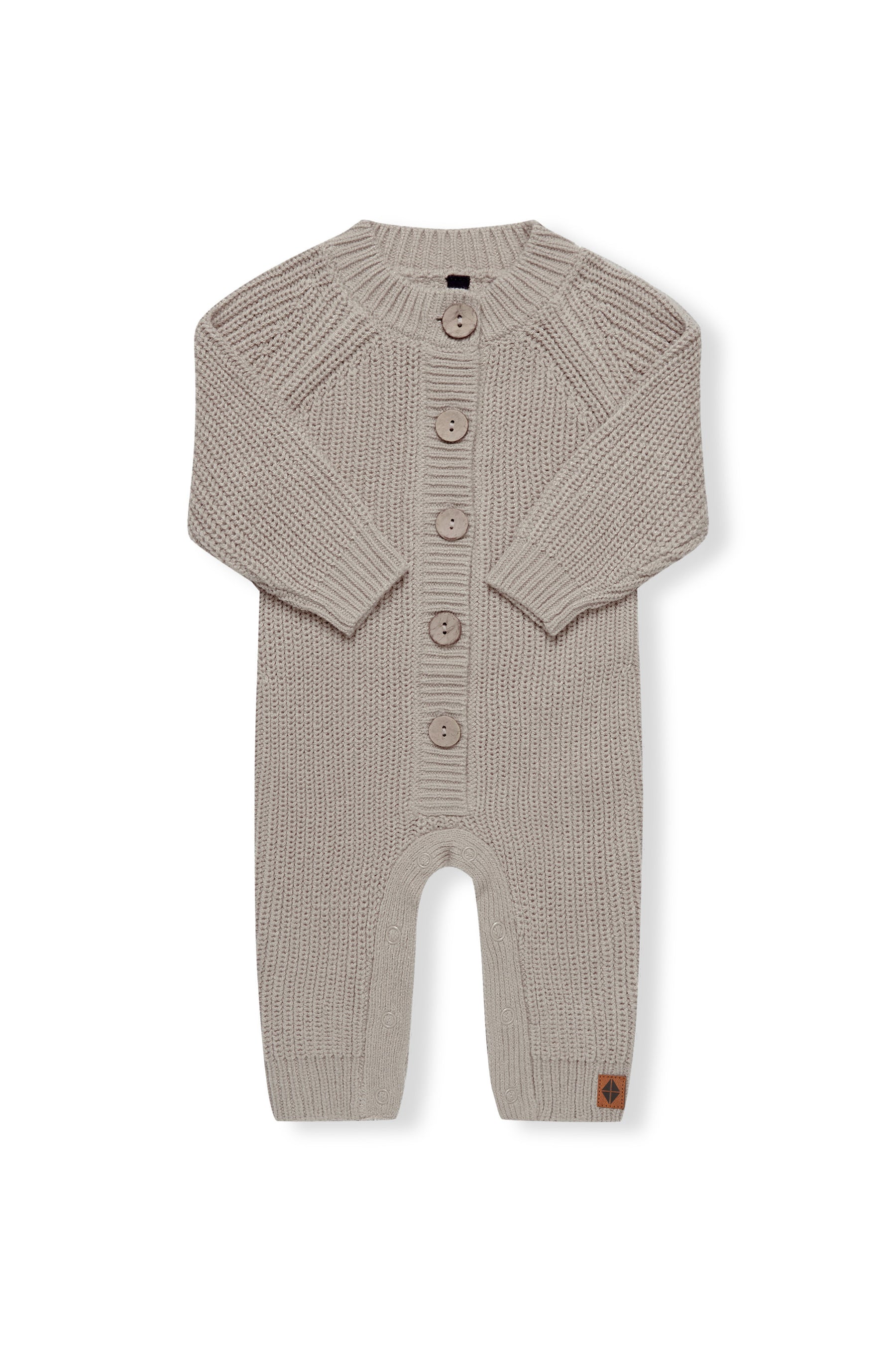 Chunky Knit Jumpsuit in Almond with folded sleeves on a white background