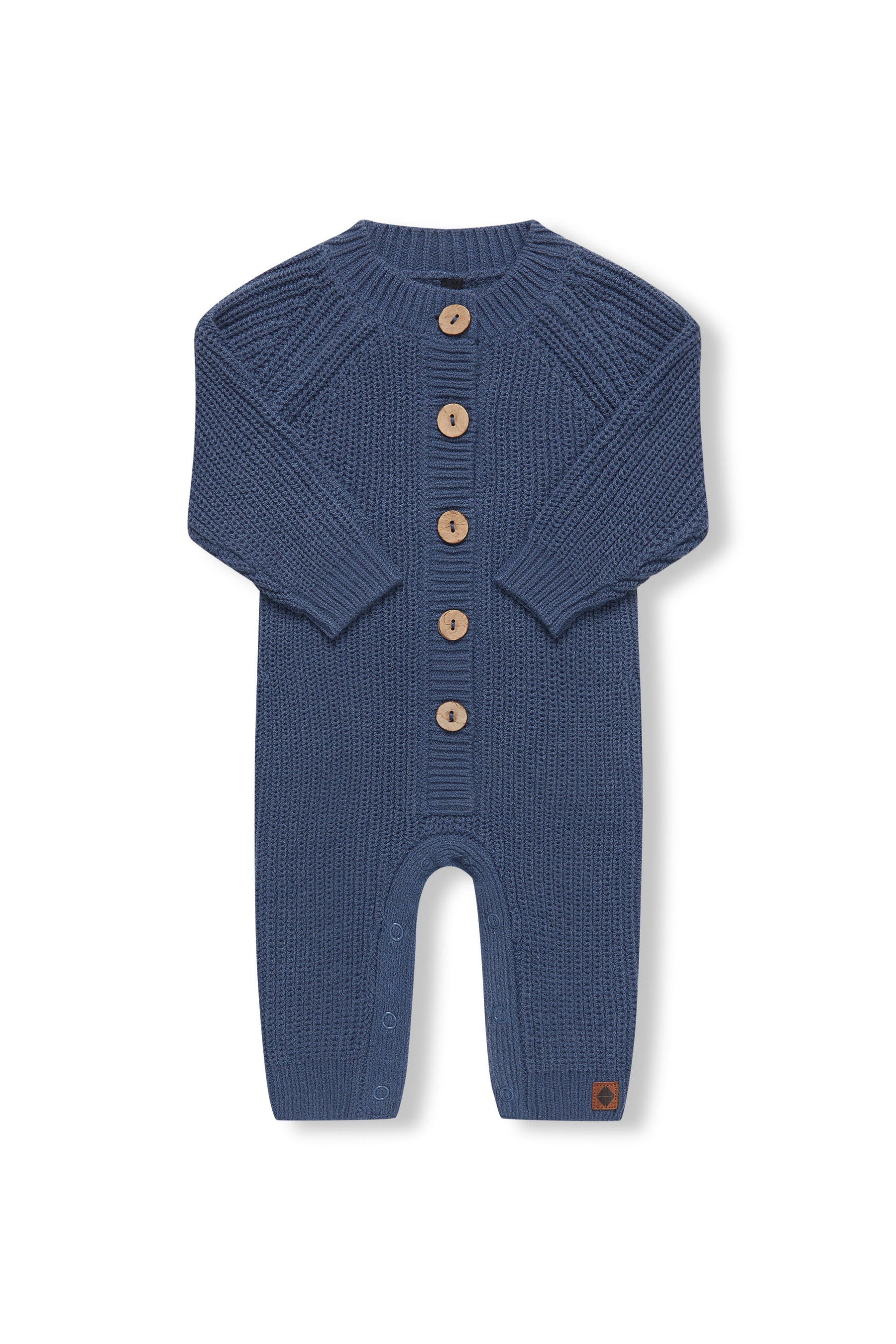 Chunky Knit Jumpsuit in Oxford with folded sleeves on a white background