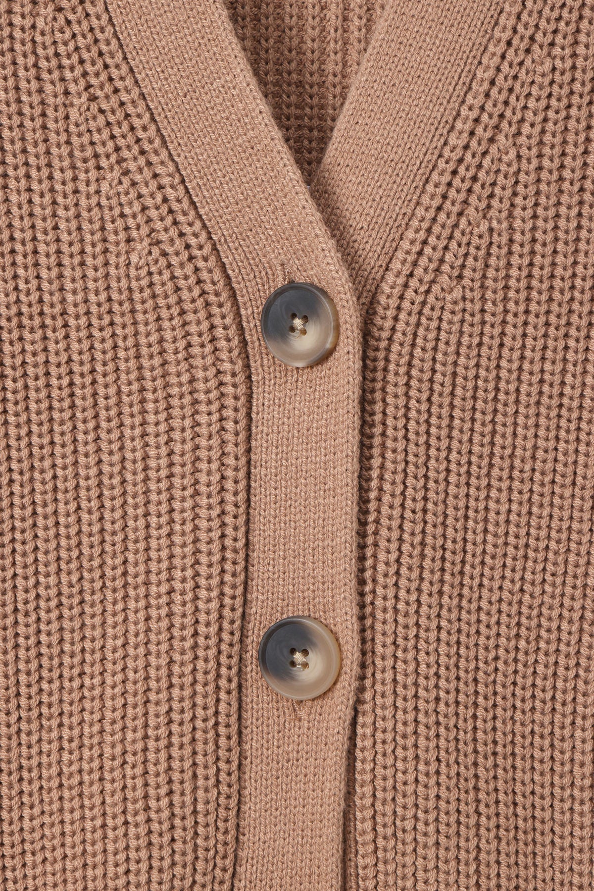 Close-up of a ribbed knit cardigan in a warm taupe-beige color, featuring three dark gray buttons down the front center.