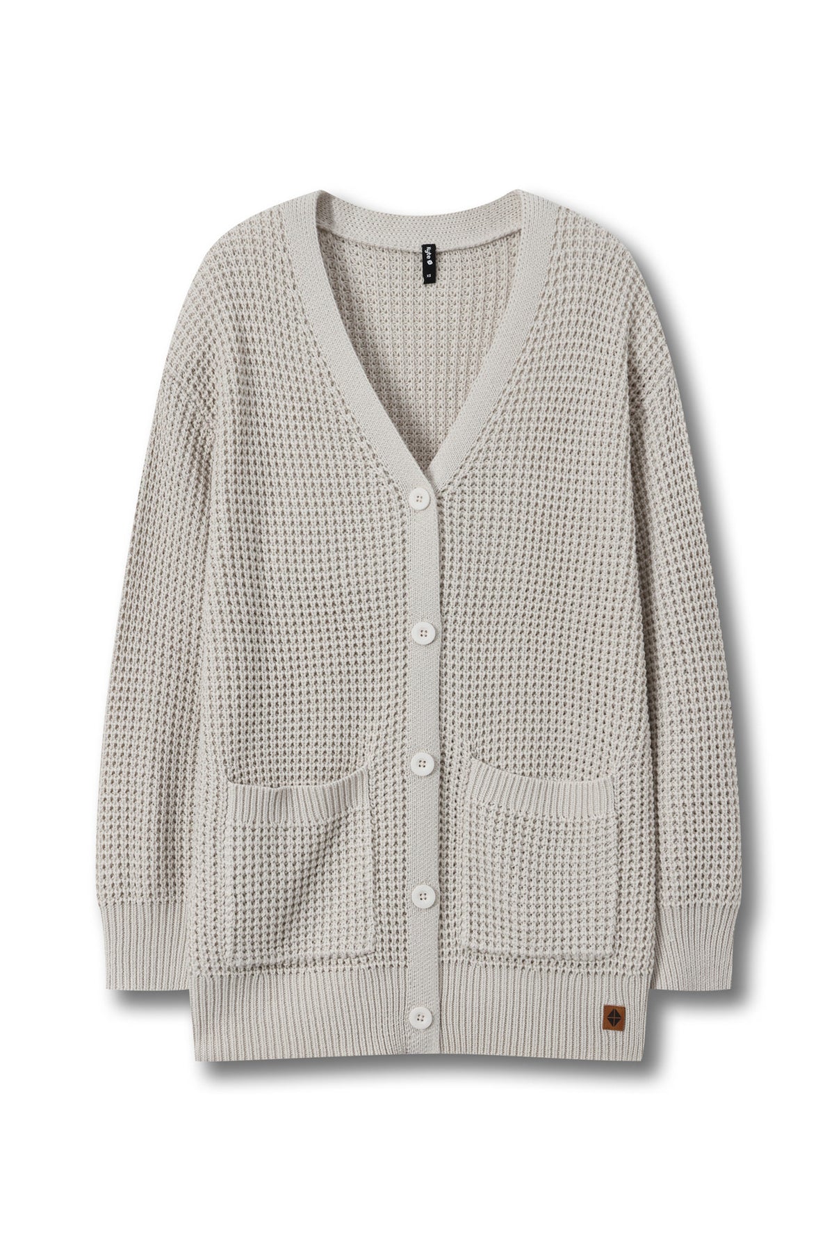 A light beige waffle-knit cardigan sweater with a V-neck, white buttons, and two front patch pockets, shown against a plain white background.