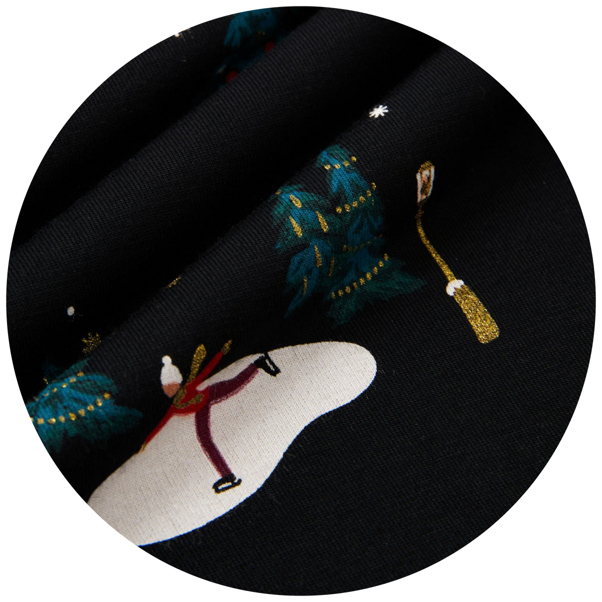 swatch of black fabric with winter elements including trees, light post, ice skater