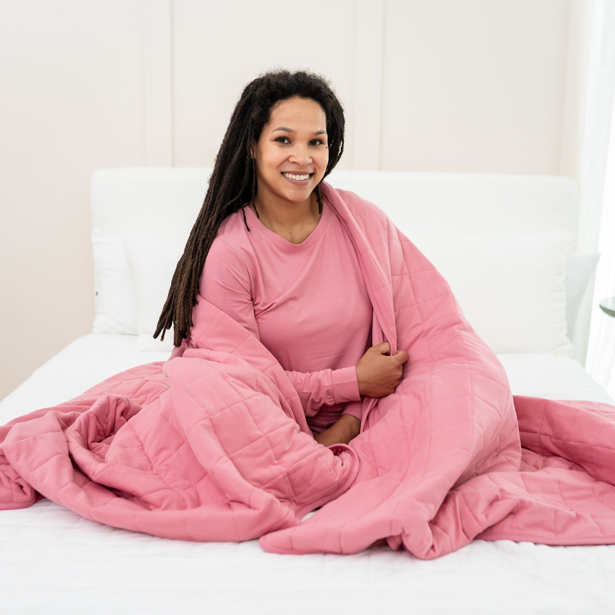 Woman in Apple Blossom Jogger Set wrapped in Adult Quilted Blanket in Apple Blossom 2.5