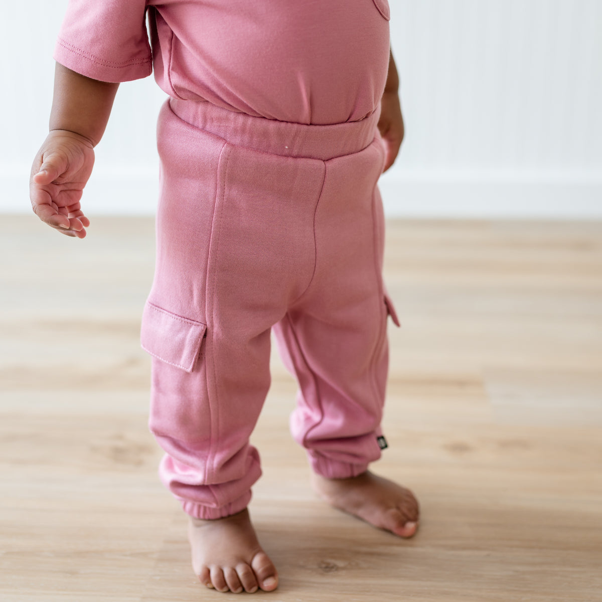 Fleece Cargo Pants in Apple Blossom shown on a toddler