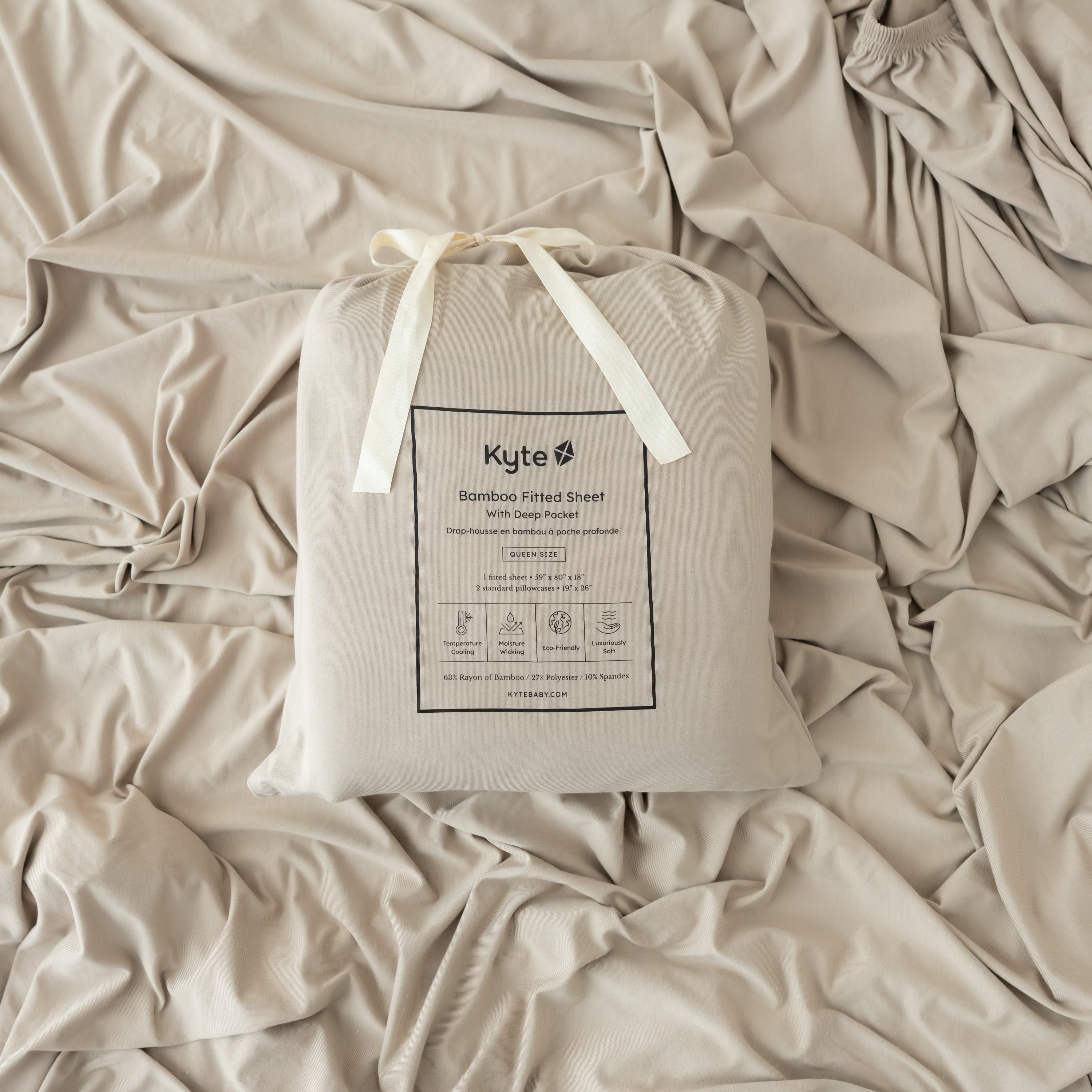 almond sheet packaging shown laying on an almond fitted sheet