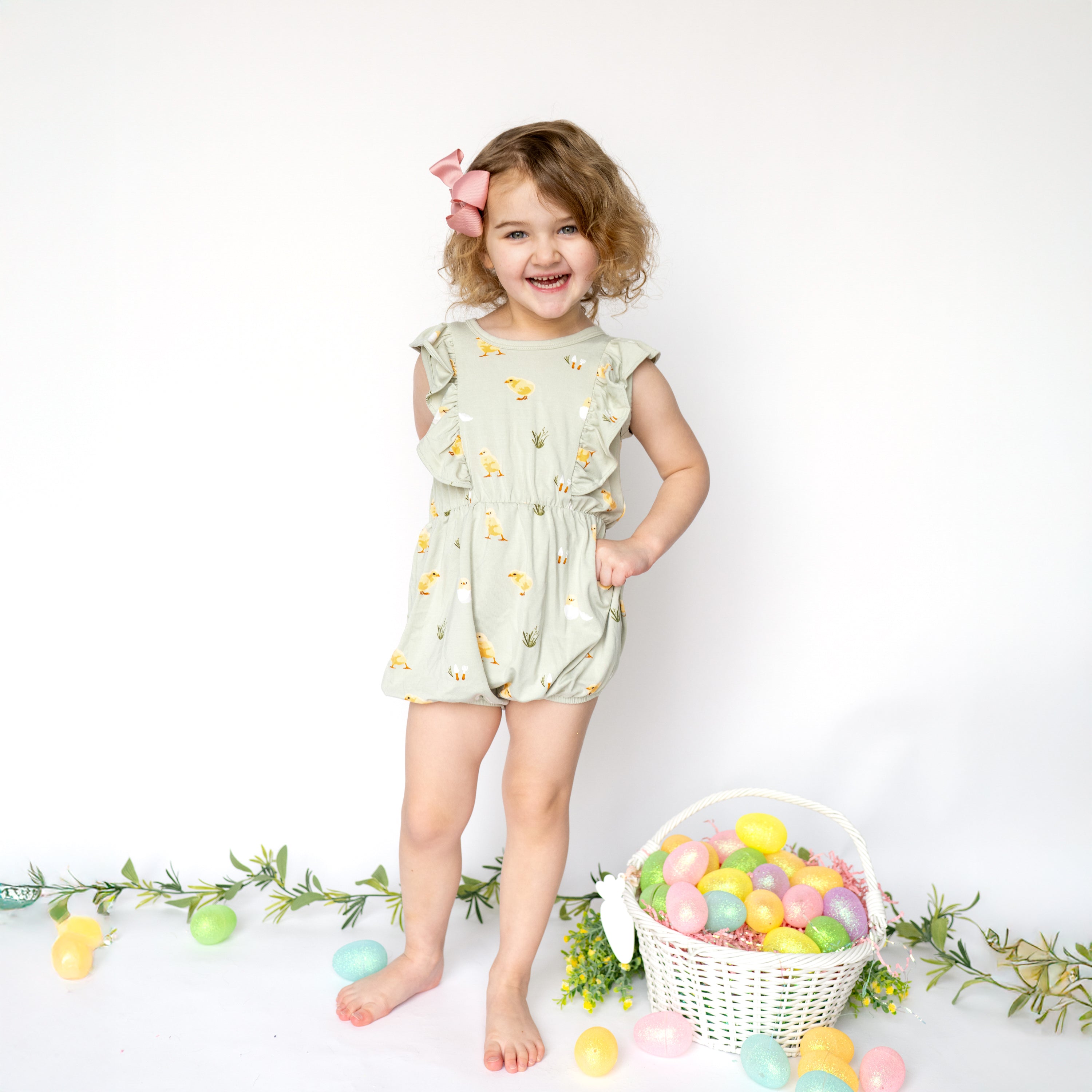 Child modeling Bubble Romper in Aloe Chick