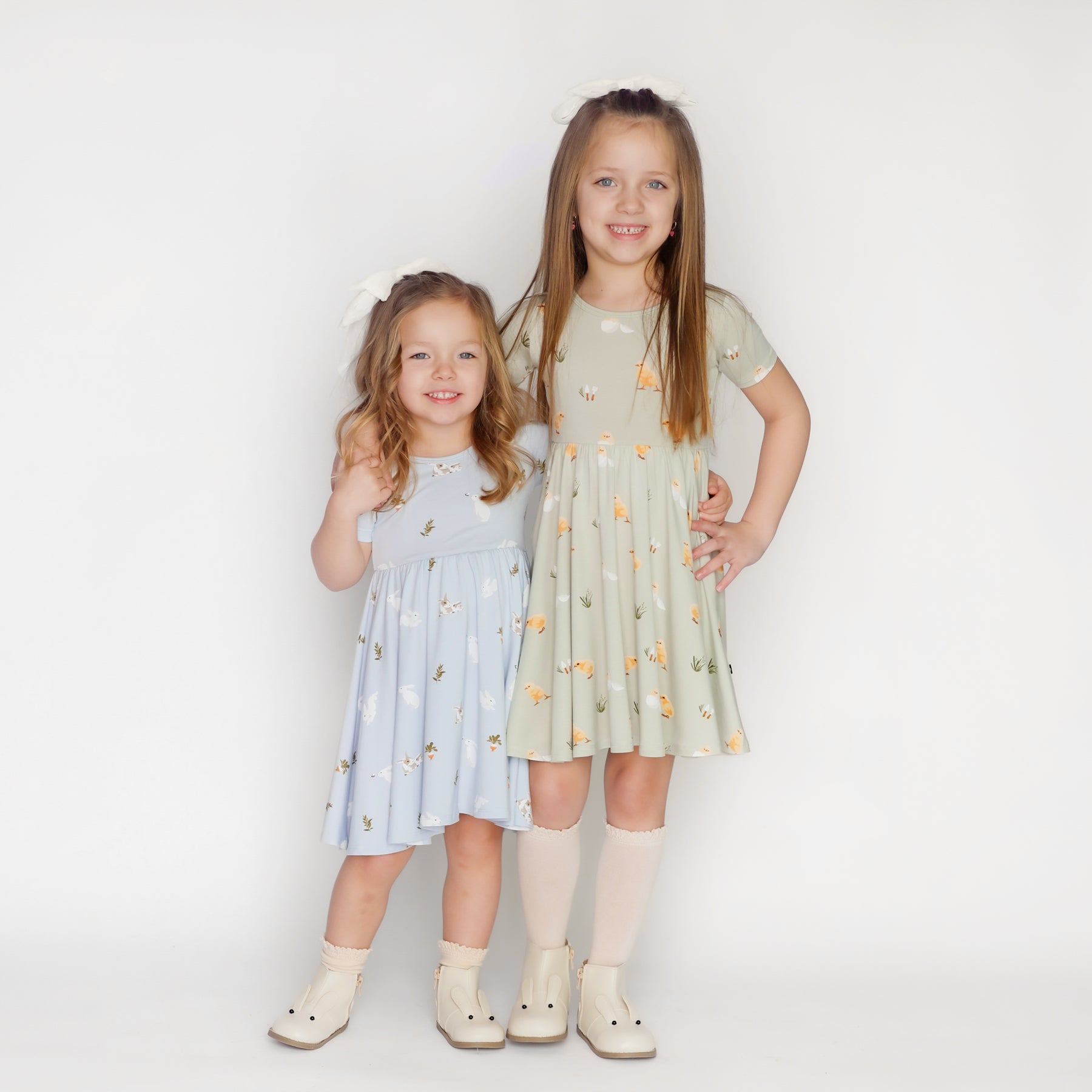 2 children modeling twirl dresses in ice rabbit and aloe chick