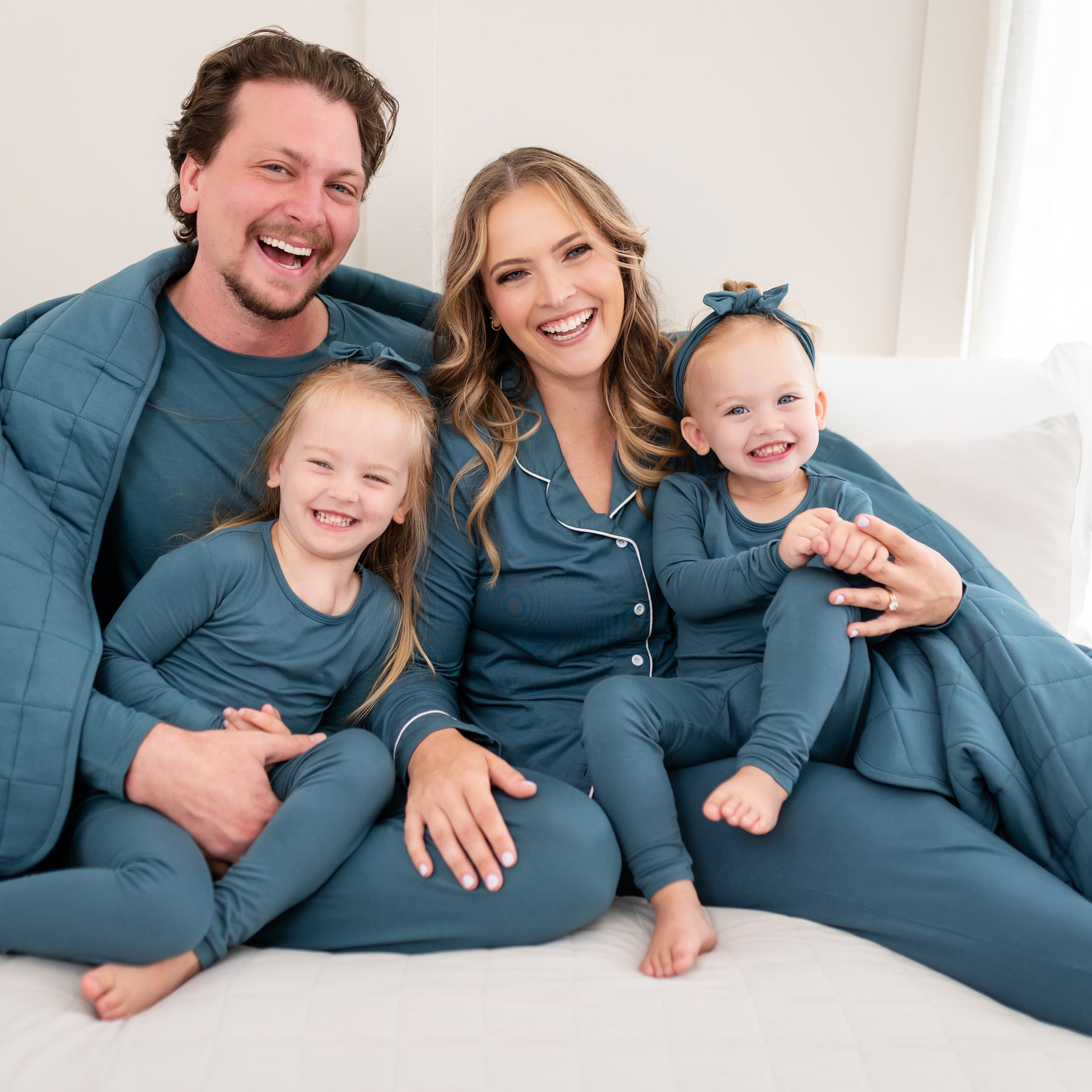 Family matching in Atlantic. Parents wearing adult pajamas while the children are wearing Long Sleeve Pajamas in Atlantic