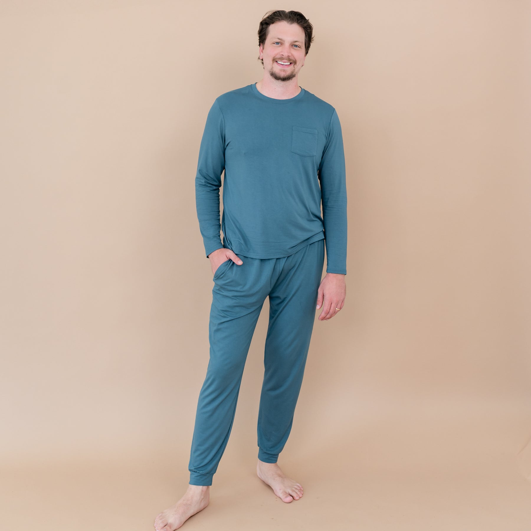 Male model standing wearing the Men's Jogger Set in Atlantic with one hand in the jogger pant pocket