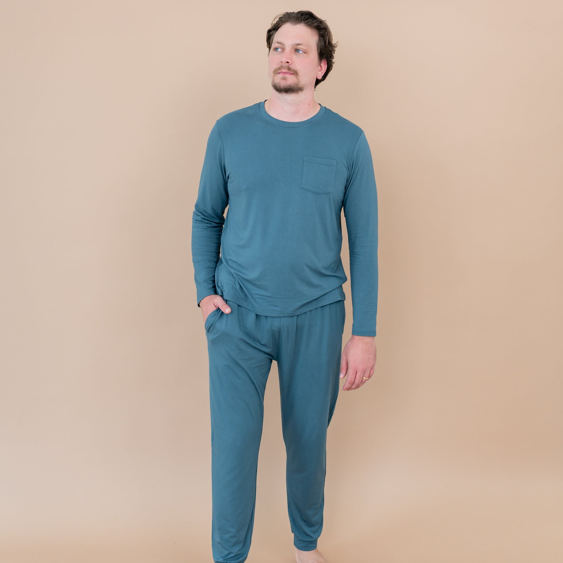 Male model walking wearing the Men's Jogger Set in Atlantic with one hand in his jogger pant pocket