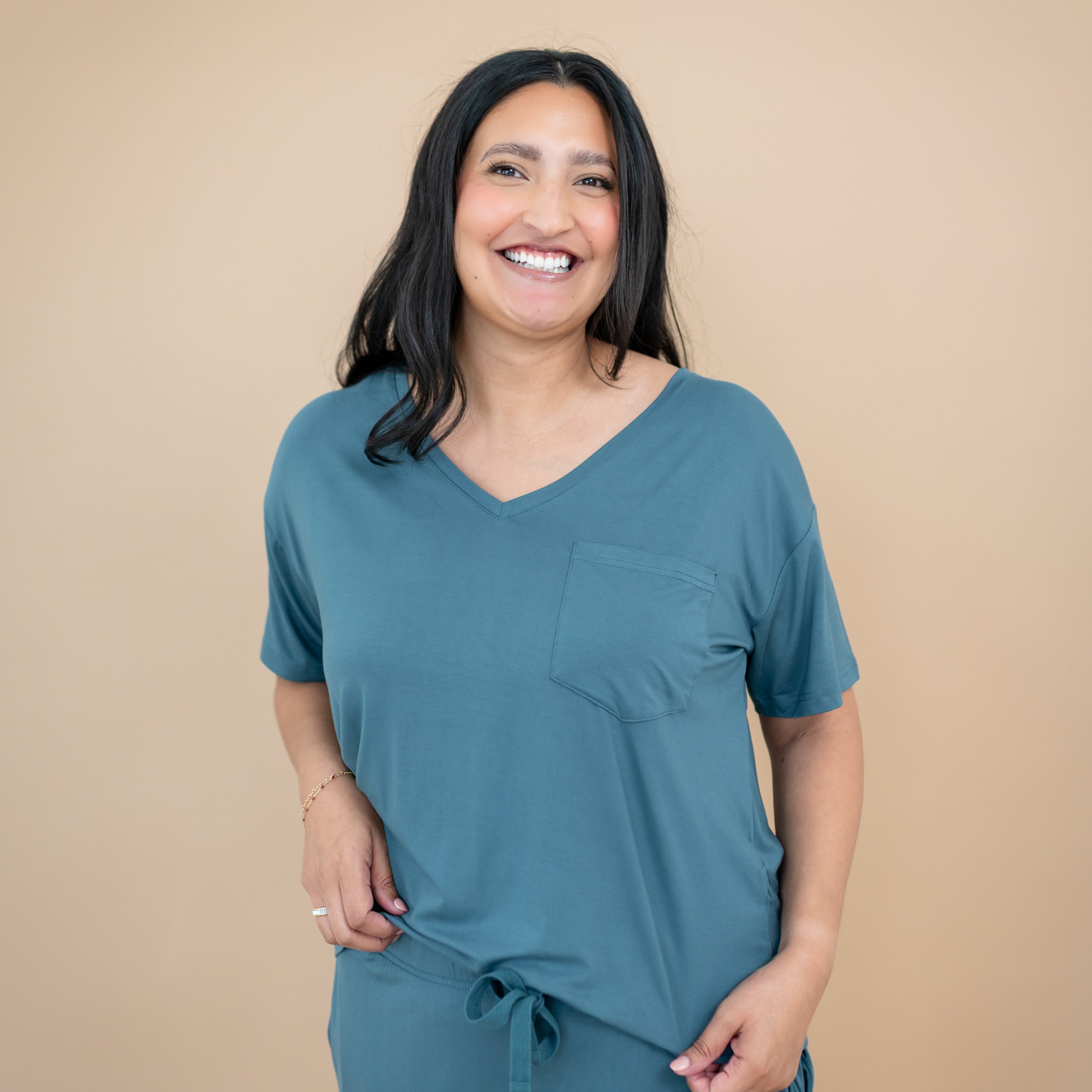 Smiling female model wearing the Women’s Relaxed Fit V-Neck in Atlantic