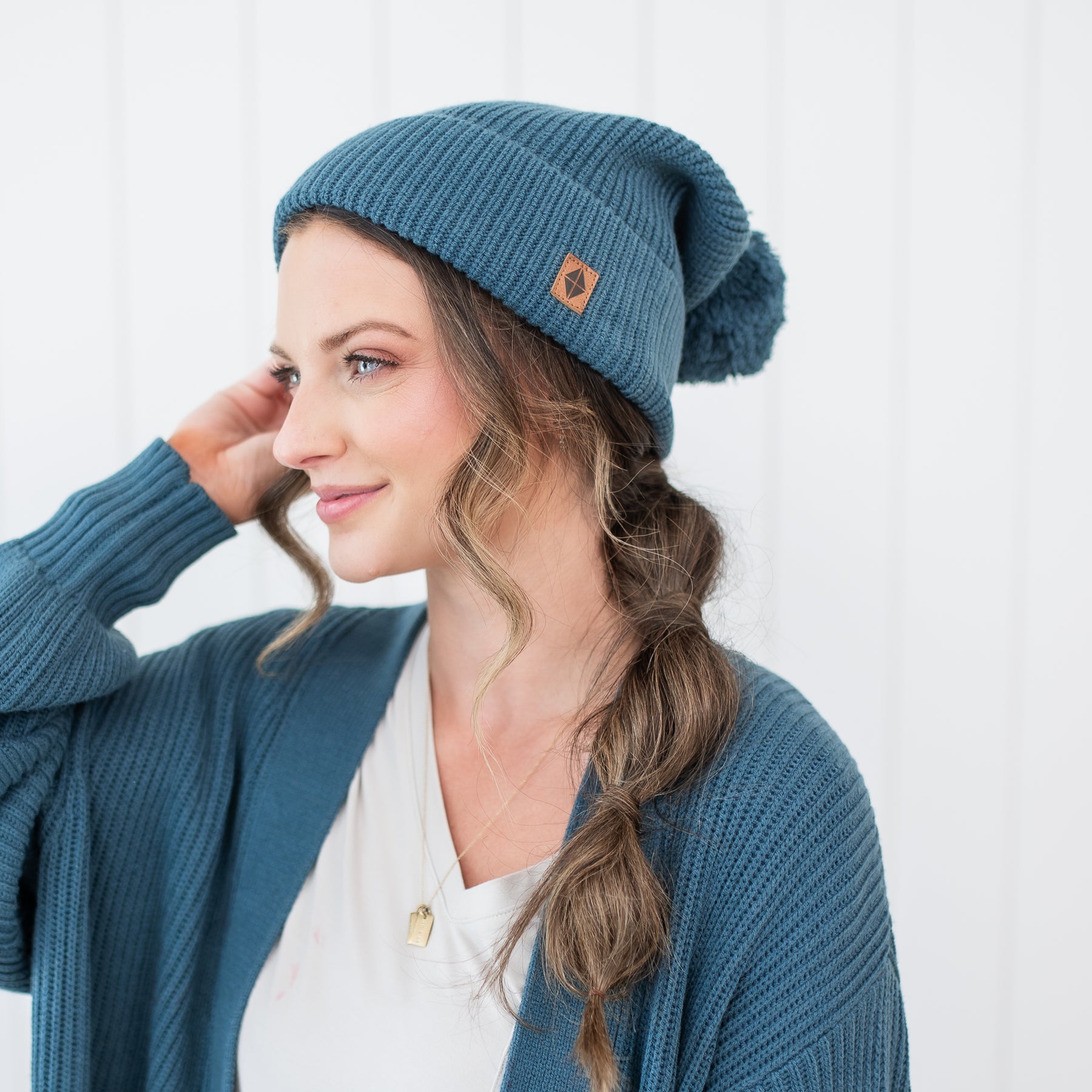 Female modeling the Chunky Knit Adult Pom Beanie in Atlantic