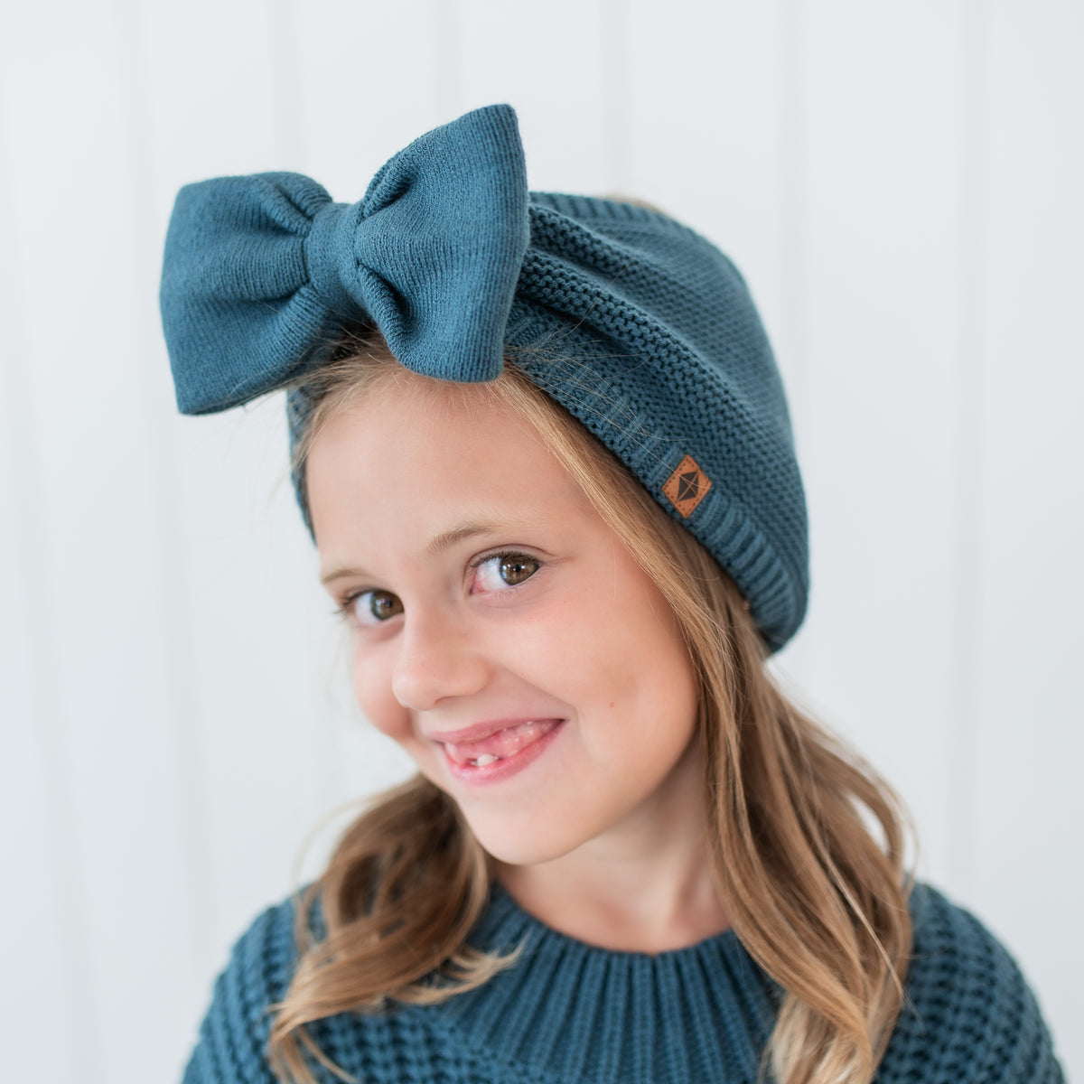 Chunky Knit Bow Headband in Atlantic shown on a young girl