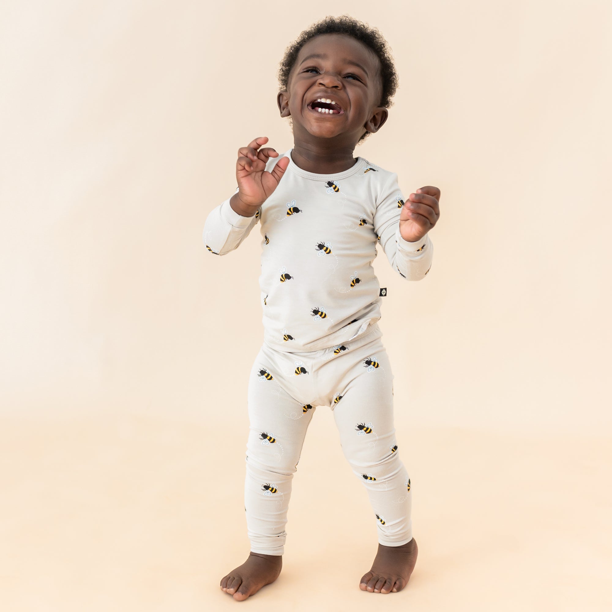 Toddler modeling Bee Mine long sleeve pajamas