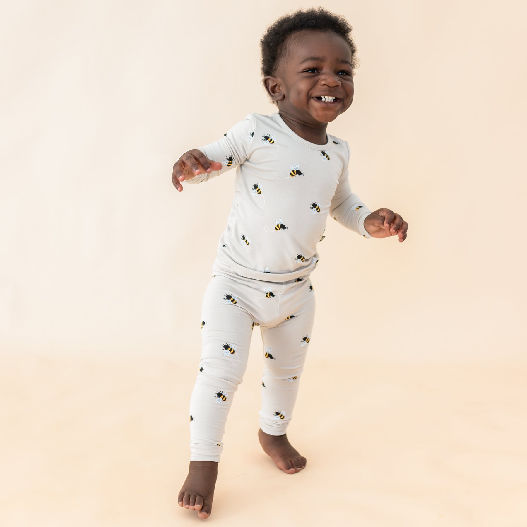 Toddler modeling Bee Mine long sleeve pajamas