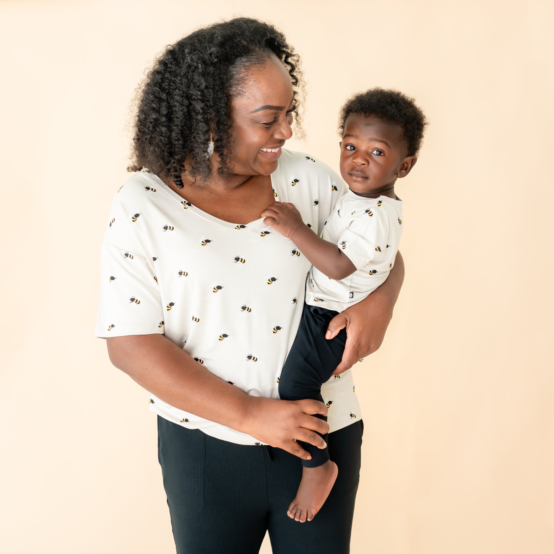 Mom wearing v-neck in Bee Mine holding toddler in Bee Mine crew neck tee