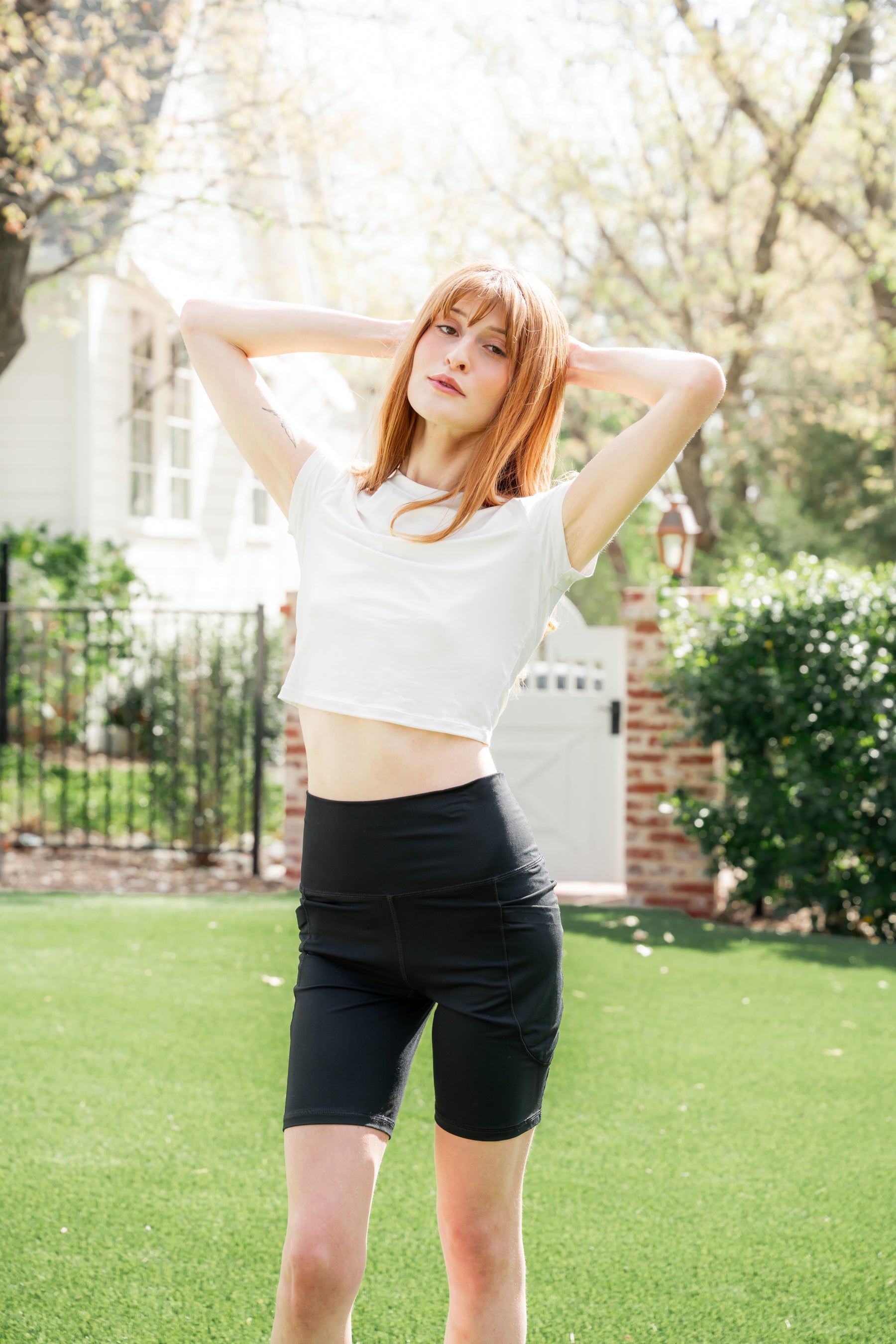 Female posing wearing the Bamboo Flex Baby Tee in Snow with the midnight biker shorts