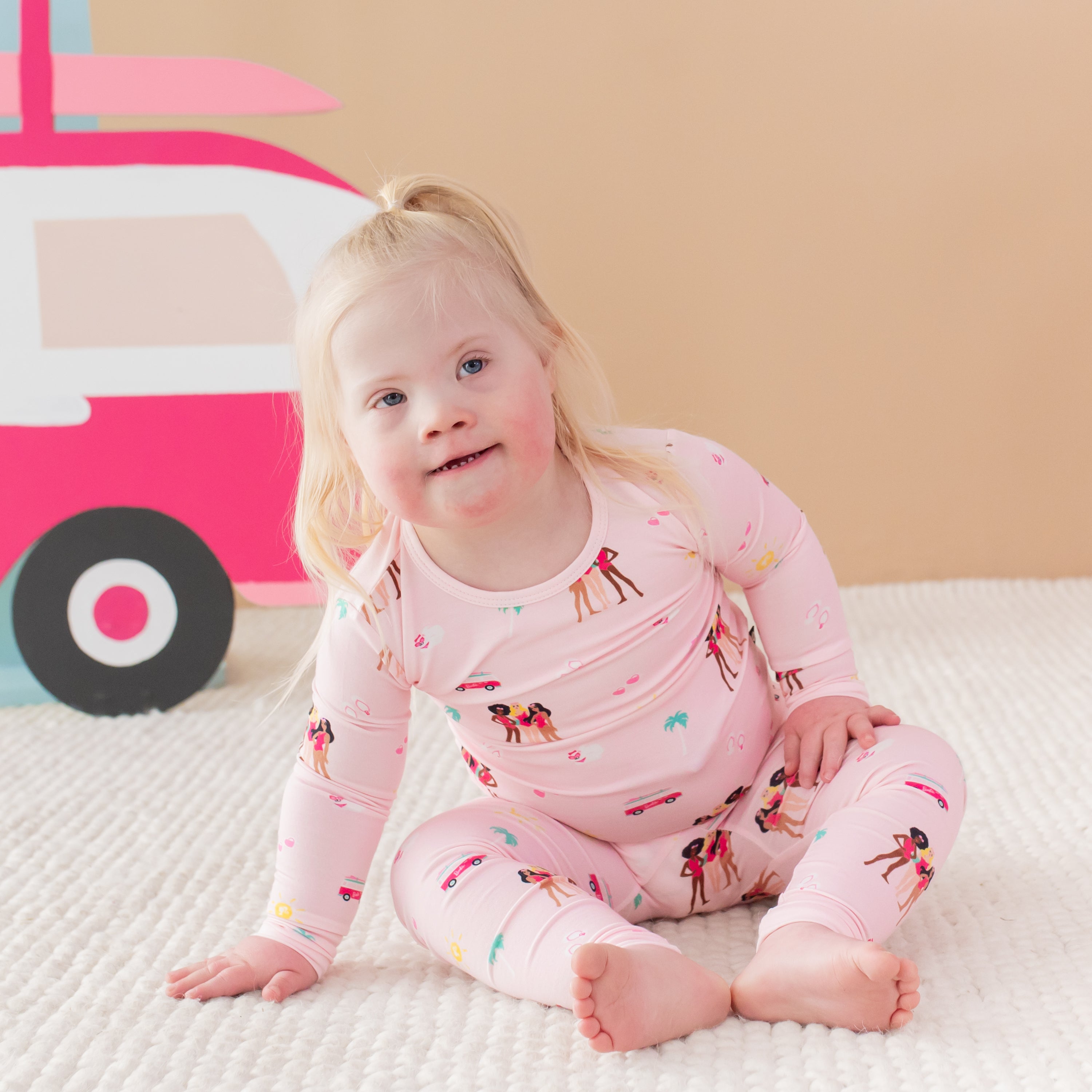 Toddler wearing Long Sleeve Pajamas in Barbie™ Beach sitting