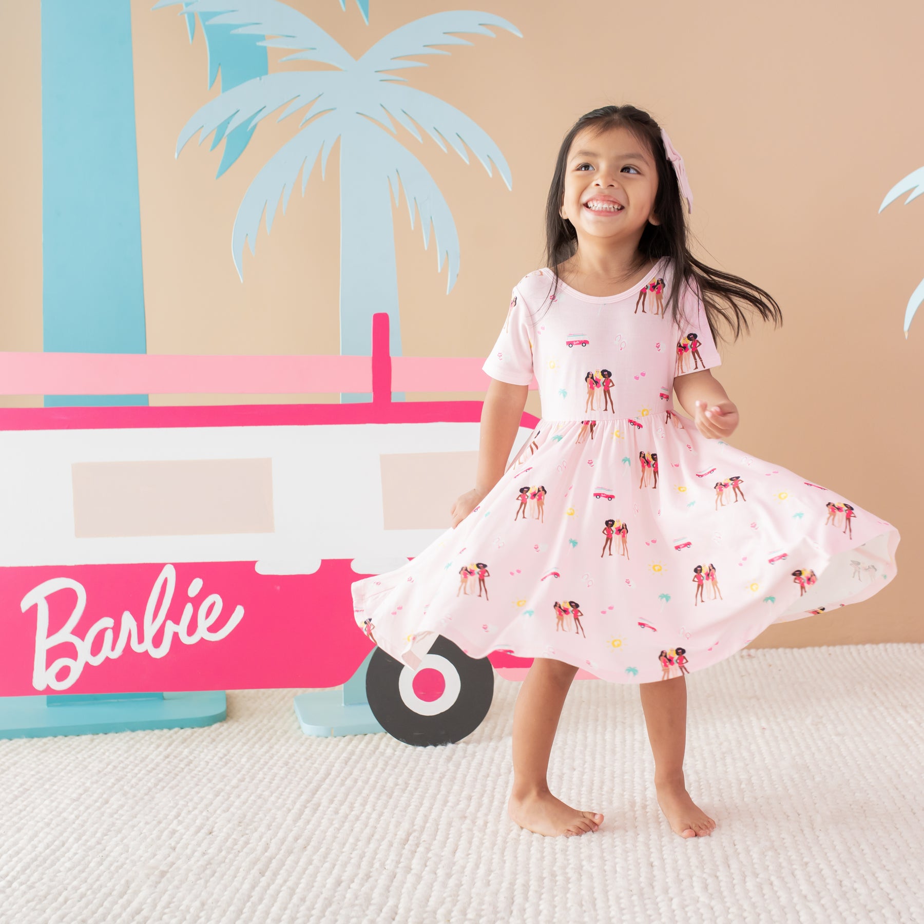 Child twirling in Twirl Dress in Barbie™ Beach