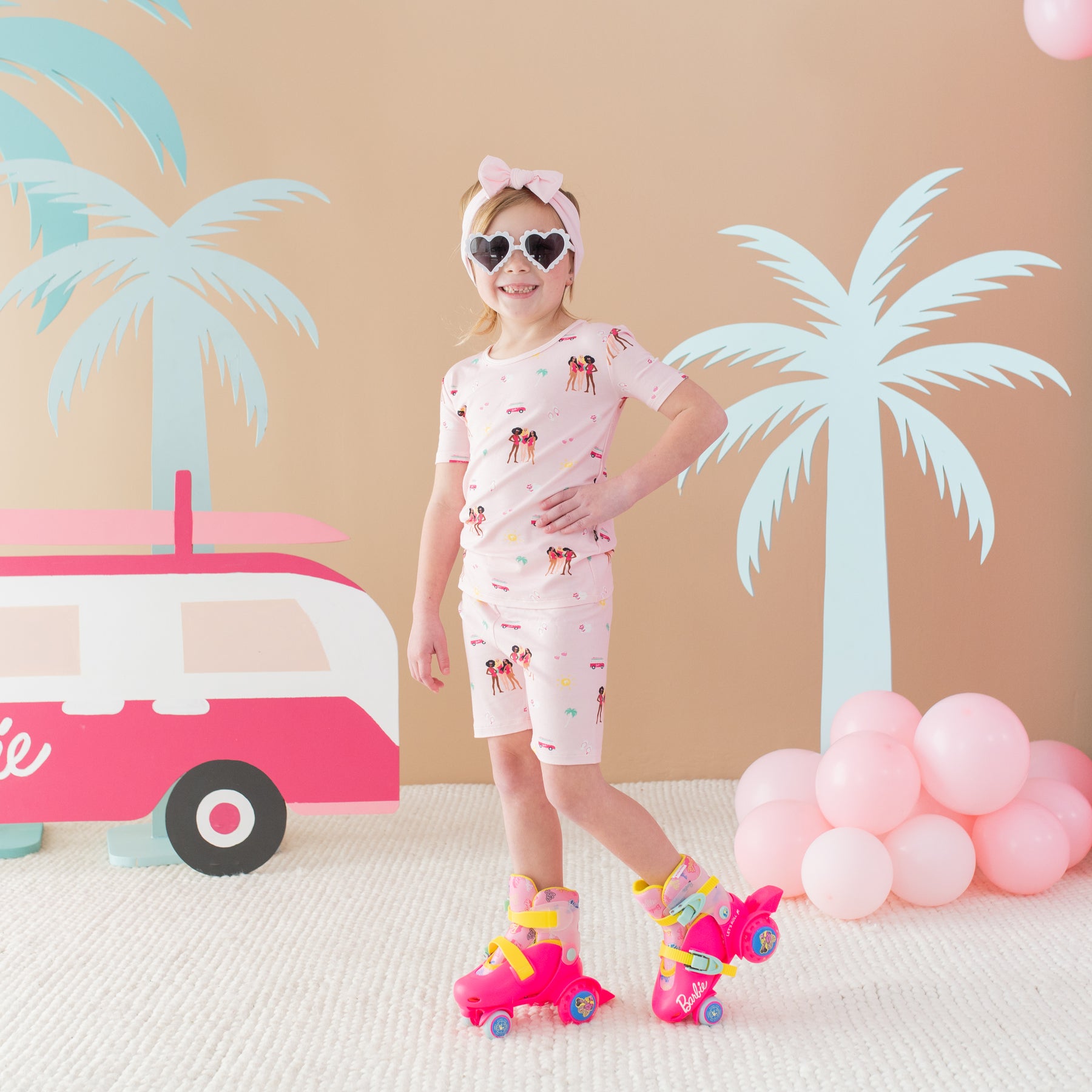 Child wearing Short Sleeve Pajamas in Barbie™ Beach wearing roller skates