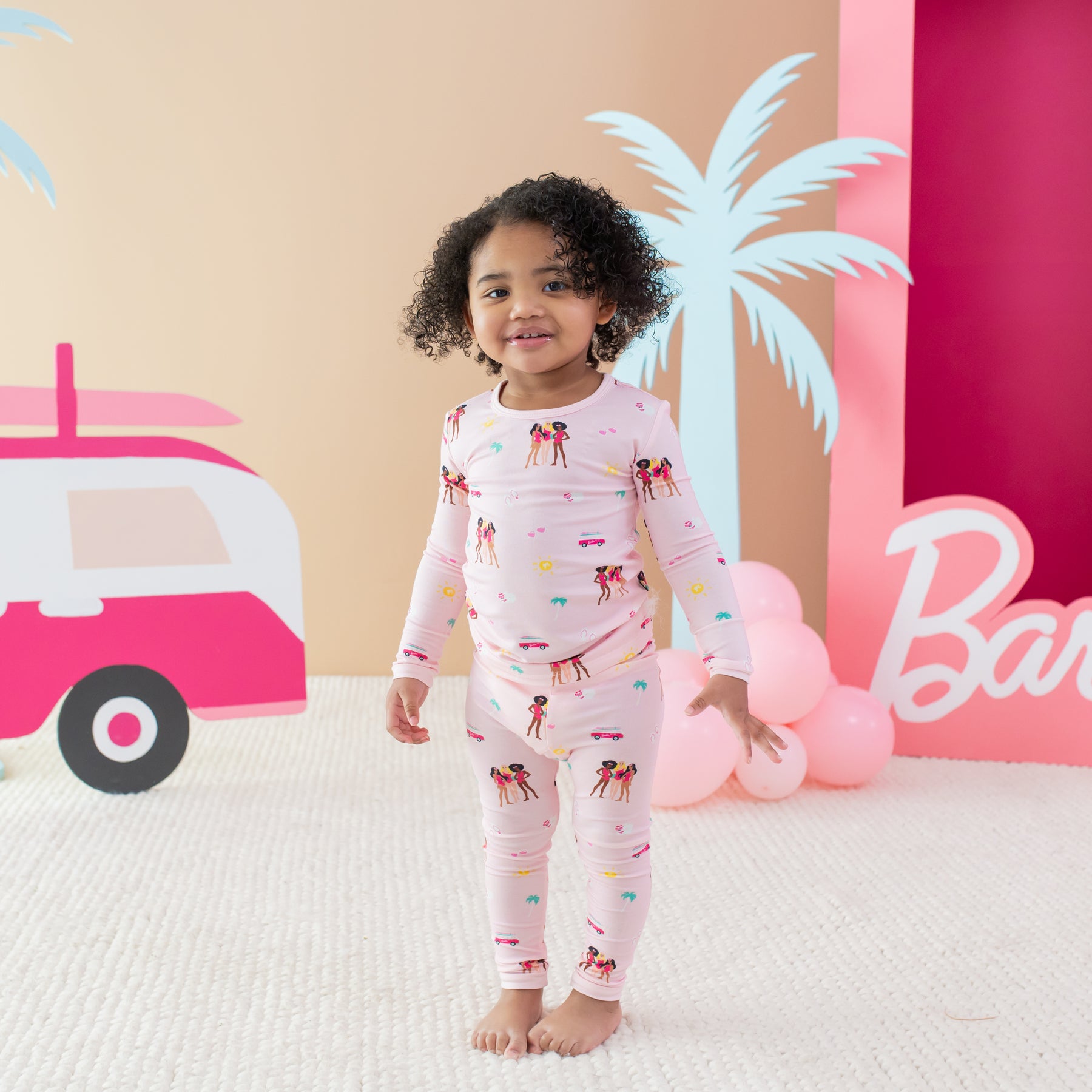 Toddler modeling Long Sleeve Pajamas in Barbie™ Beach