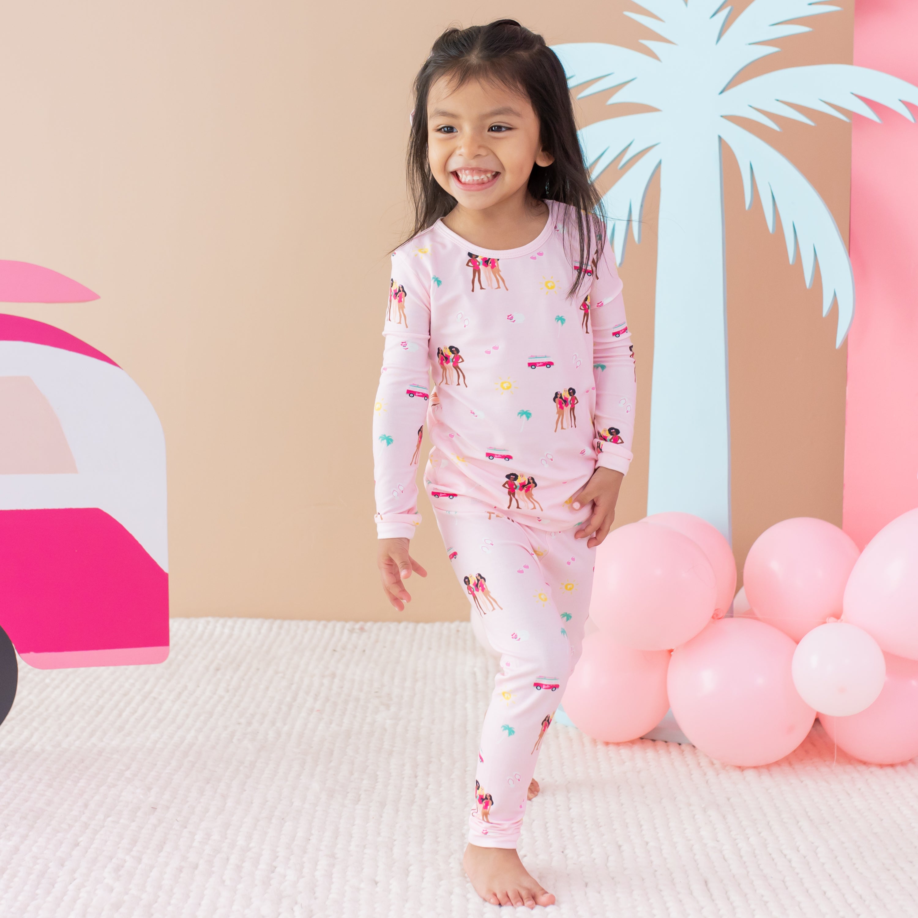 Toddler modeling Long Sleeve Pajamas in Barbie™ Beach