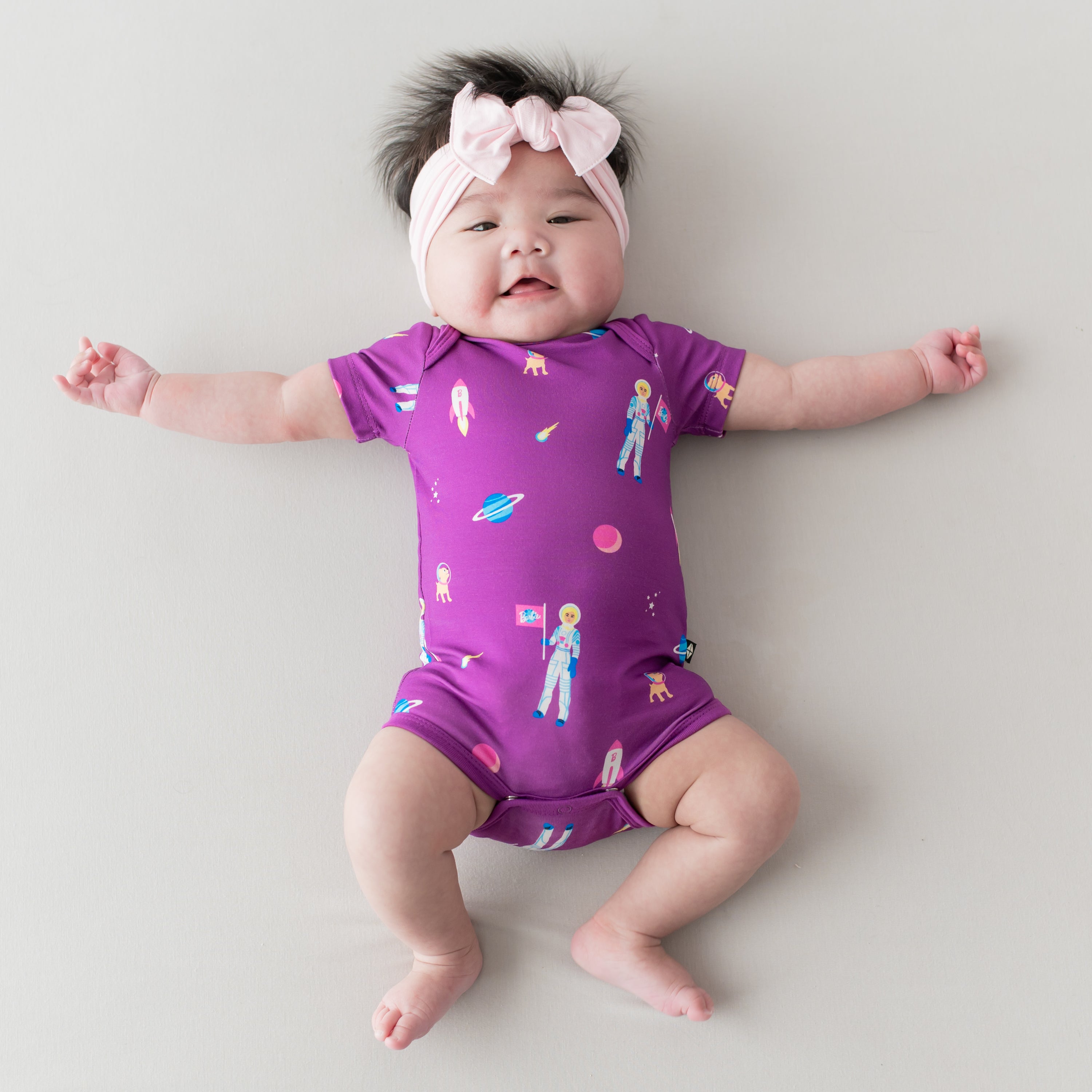 Baby in Bodysuit in Barbie™ Astronaut and Sakura bow