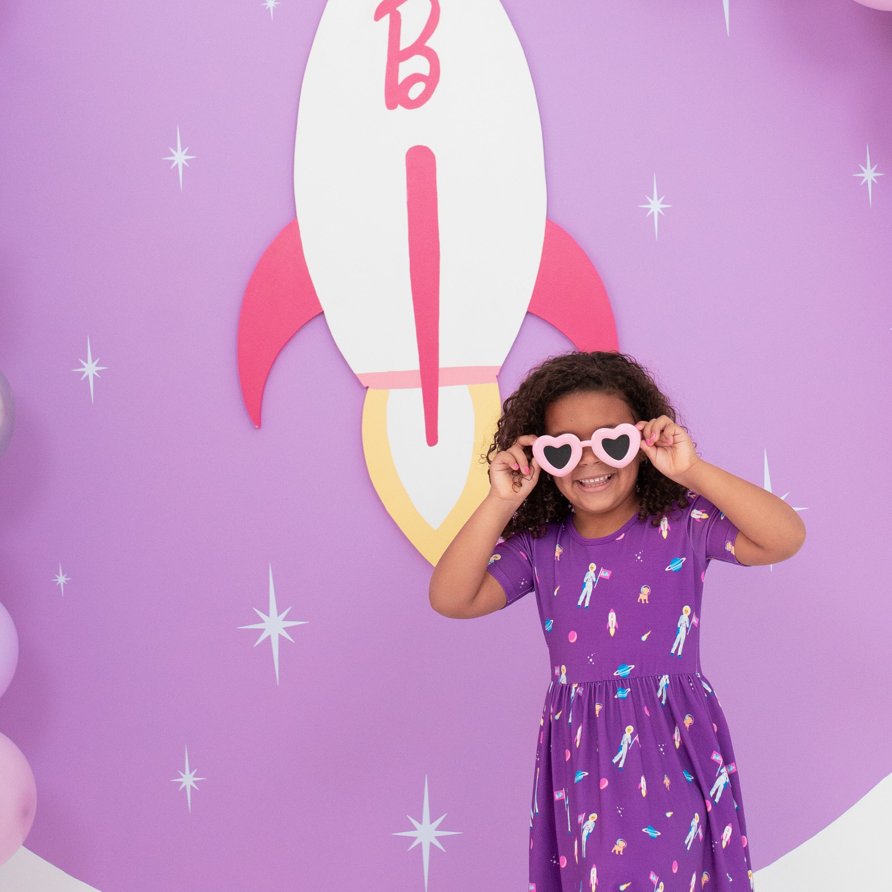 Child wearing glasses and Twirl Dress in Barbie™ Astronaut