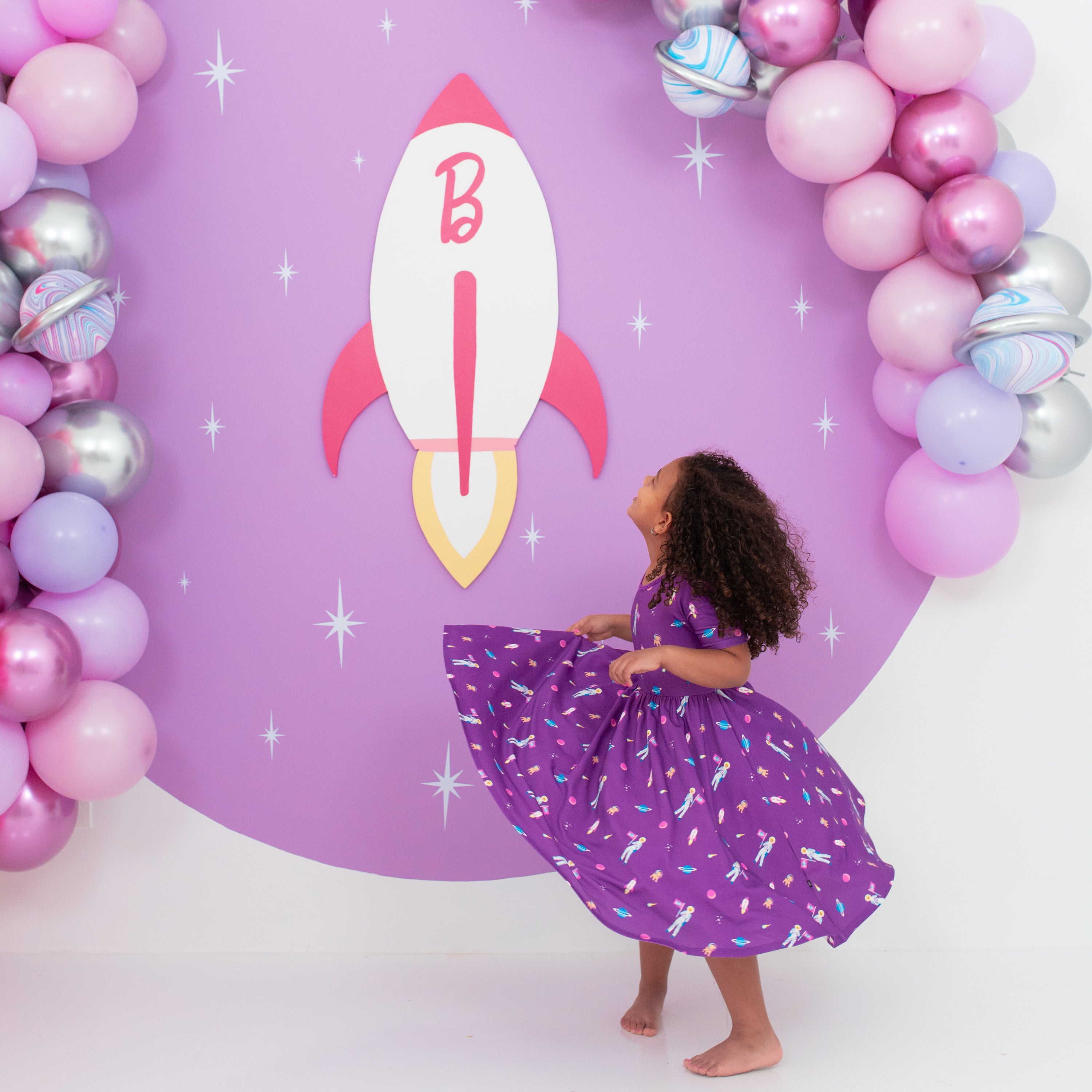 Toddler twirling in Twirl Dress in Barbie™ Astronaut