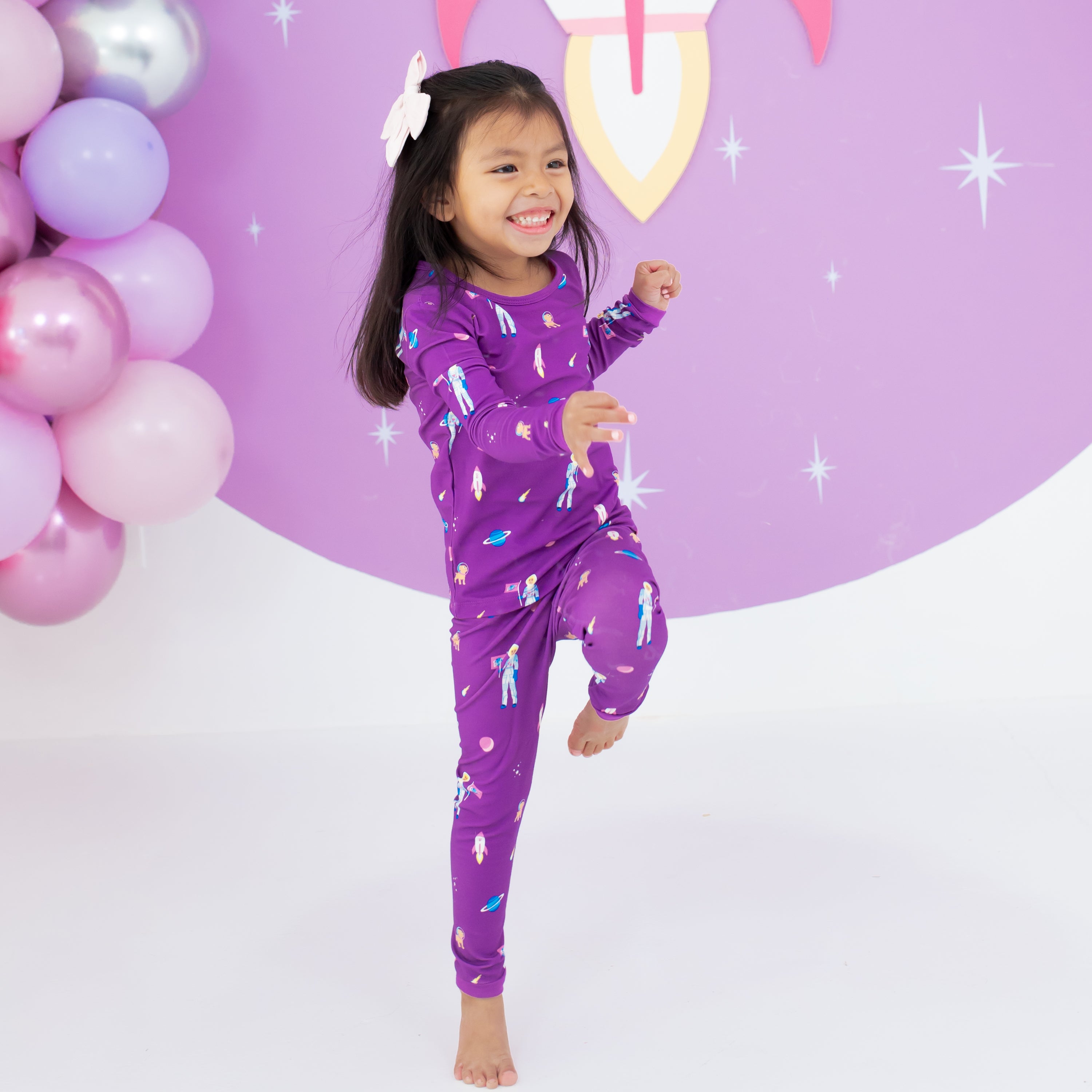 Toddler jumping wearing Long Sleeve Pajamas in Barbie™ Astronaut