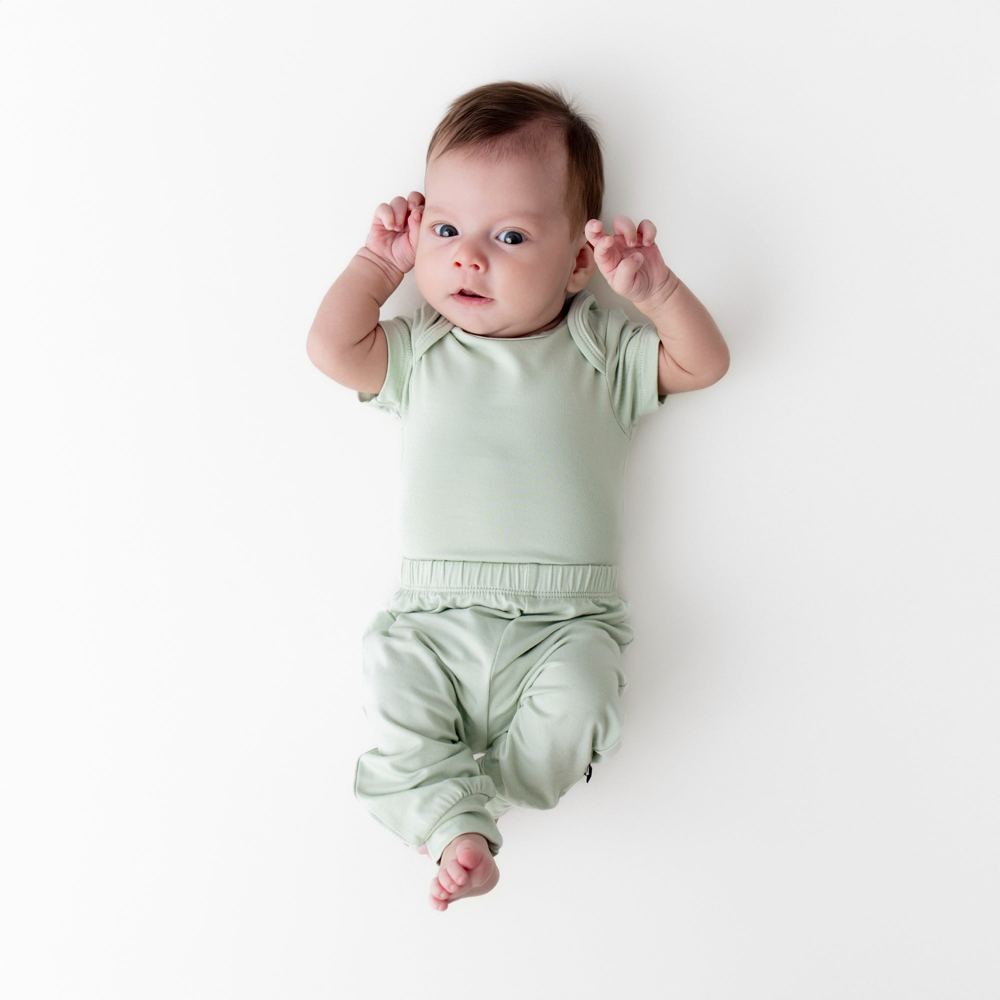 Newborn wearing the Pant in Basil paired with matching short sleeve bodysuit