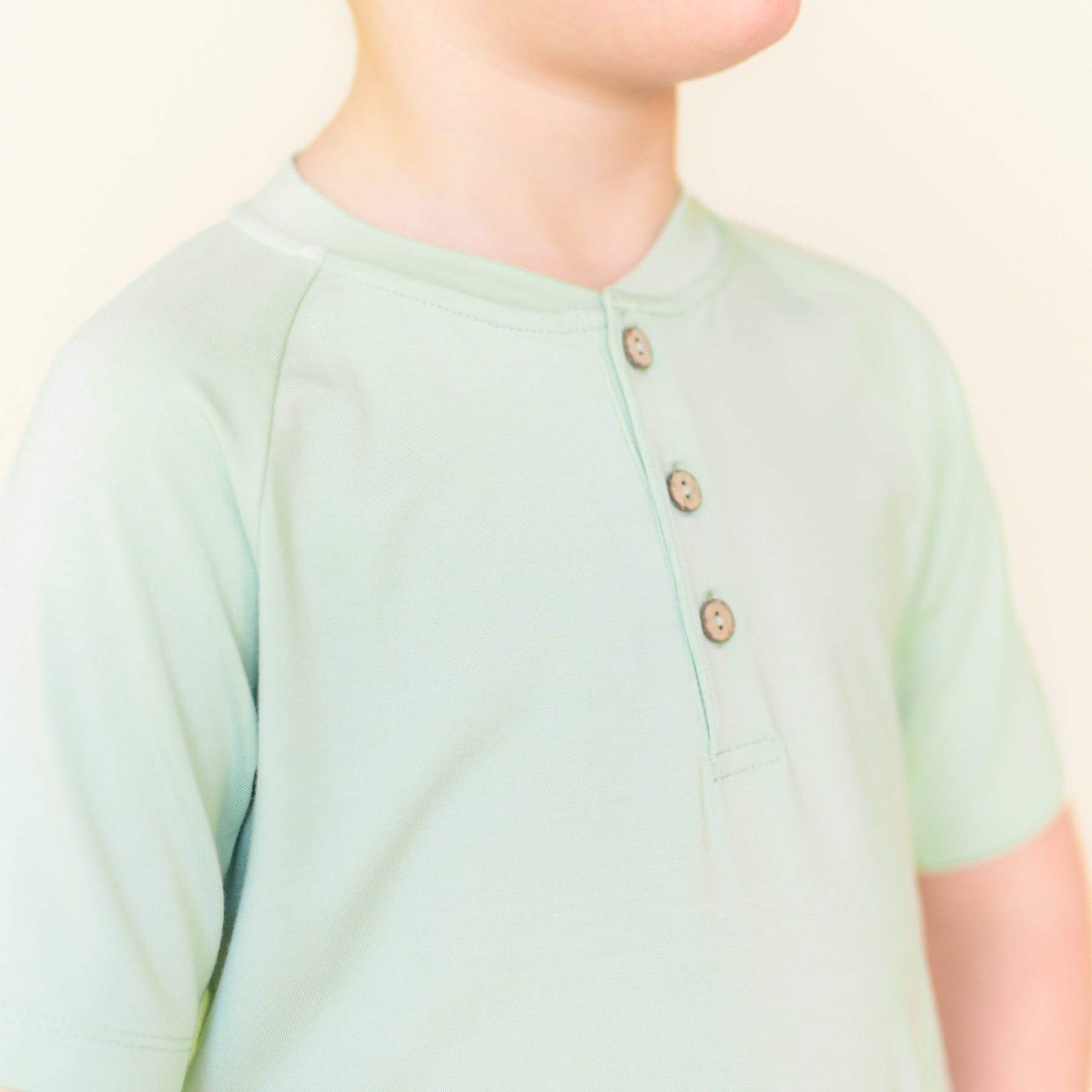 Close up of the button placket on the Short Sleeve Toddler Henley Tee in Basil