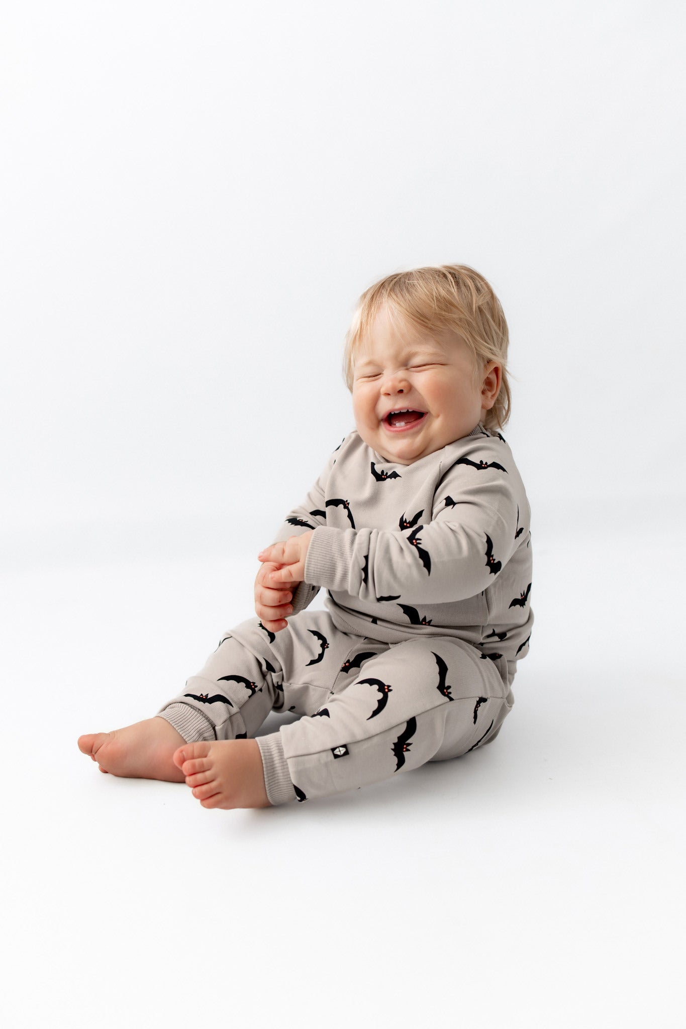 Baby sitting wearing Long Sleeve Jogger Set in Bats sitting on a white background