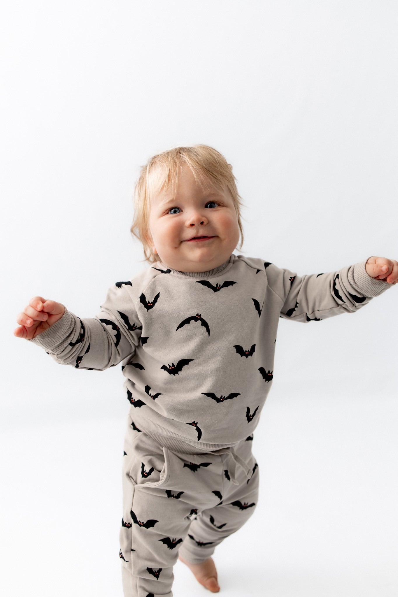 Baby wearing Long Sleeve Jogger Set in Bats print on a white background