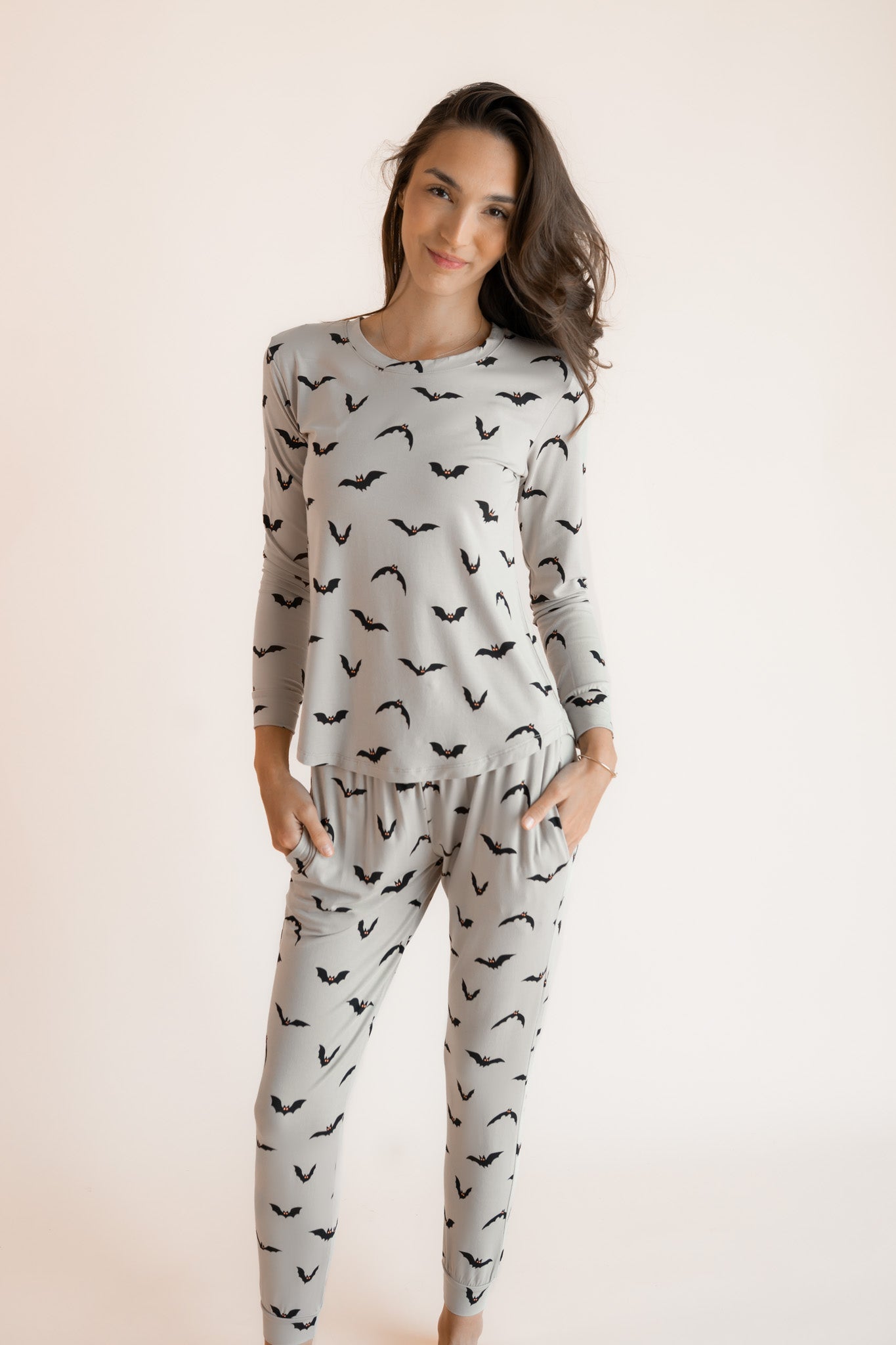 Modal posing in Women's Jogger Pajama Set in Bats print on a white background