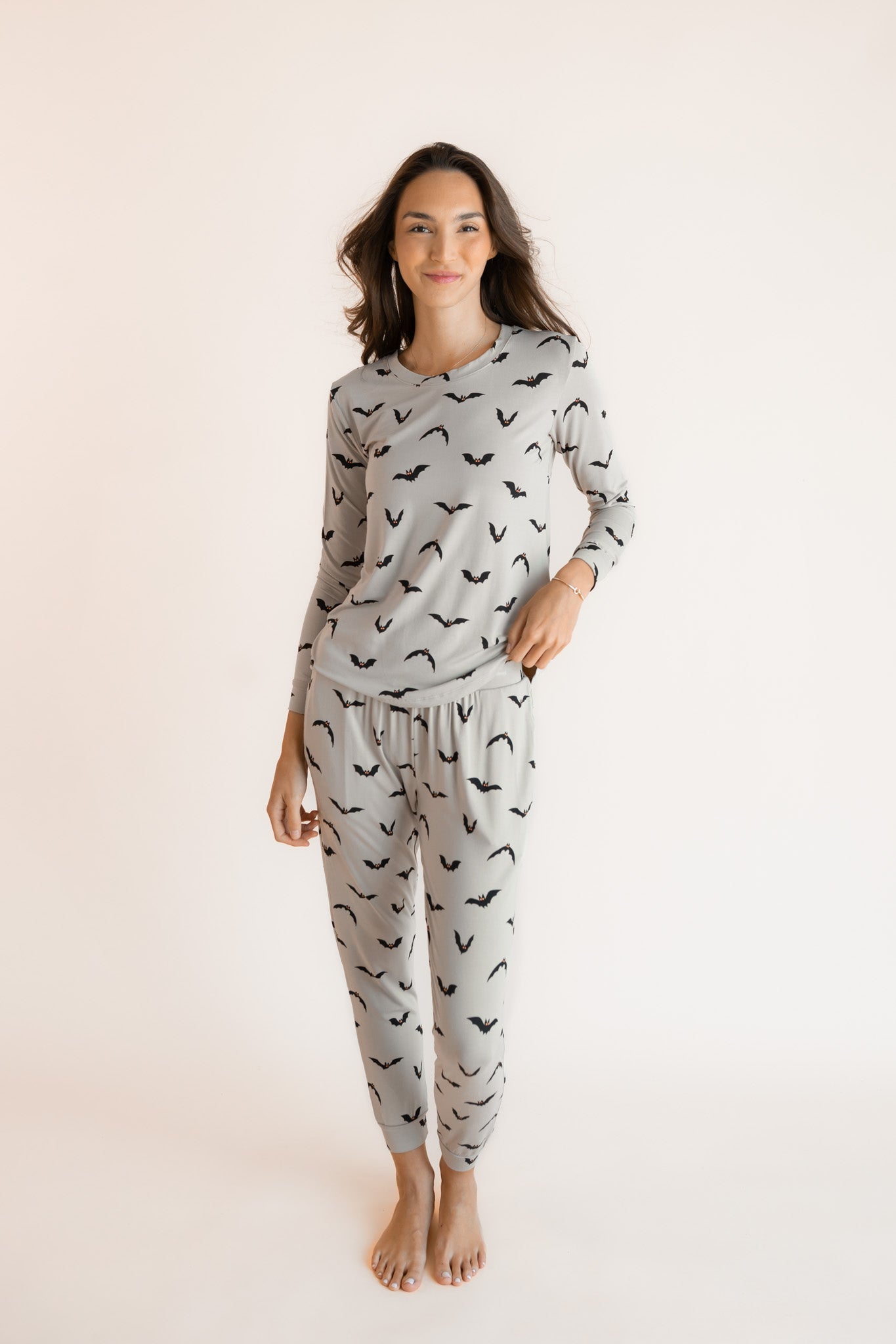 Modal wearing Women's Jogger Pajama Set in Bats print on a white background