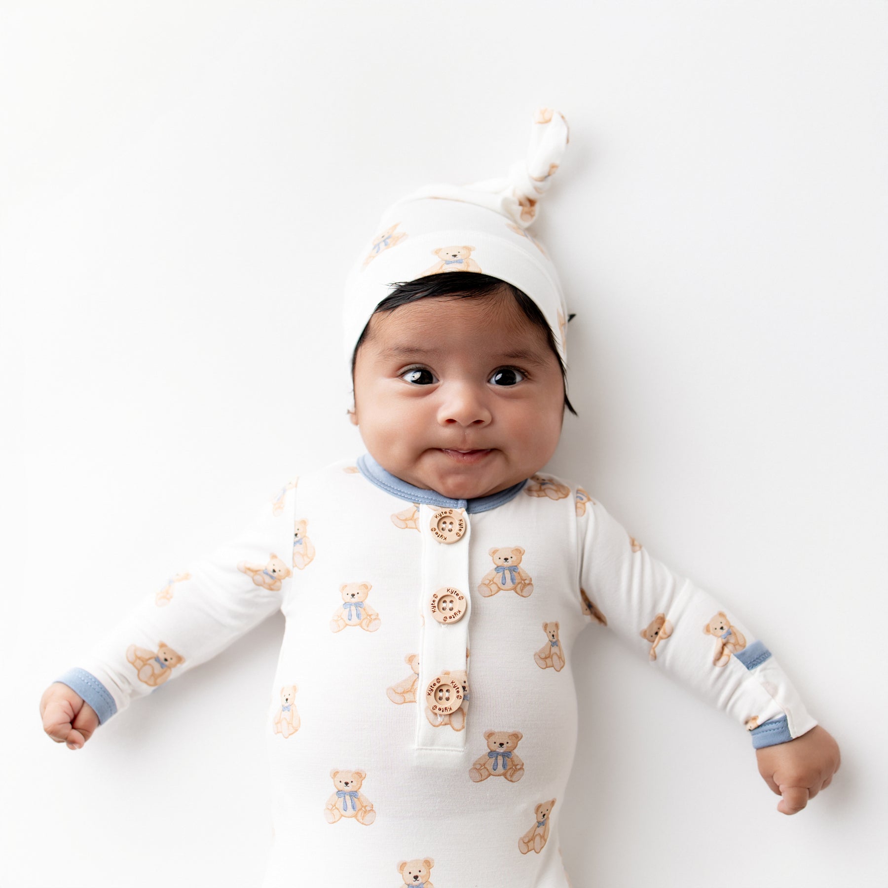 Close up of infant wearing the Knotted Gown with Hat Set in Teddy Bear