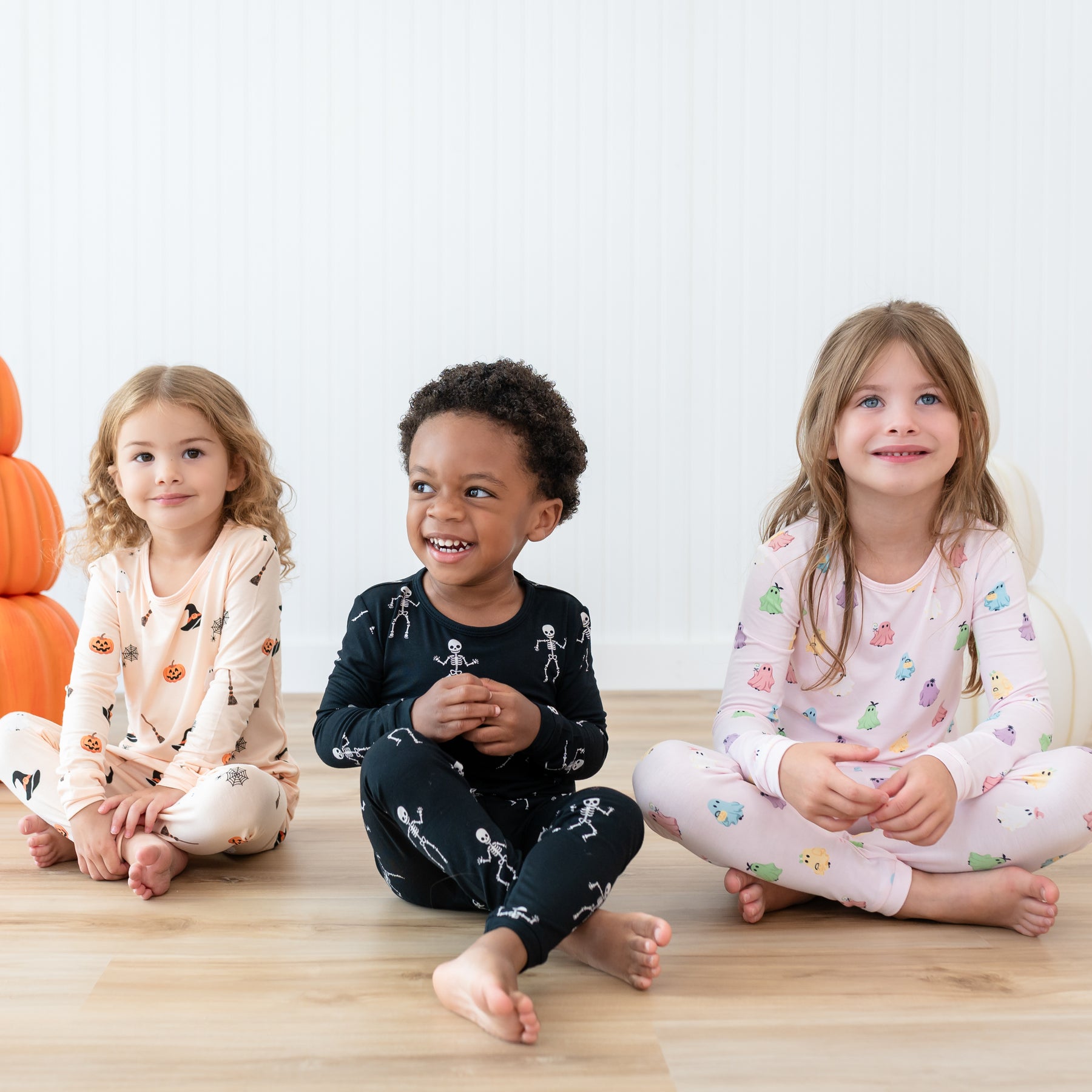 Kids wearing Long Sleeve Halloween Pajamas in Bewitched, Skeleton and Pastel Ghosts prints
