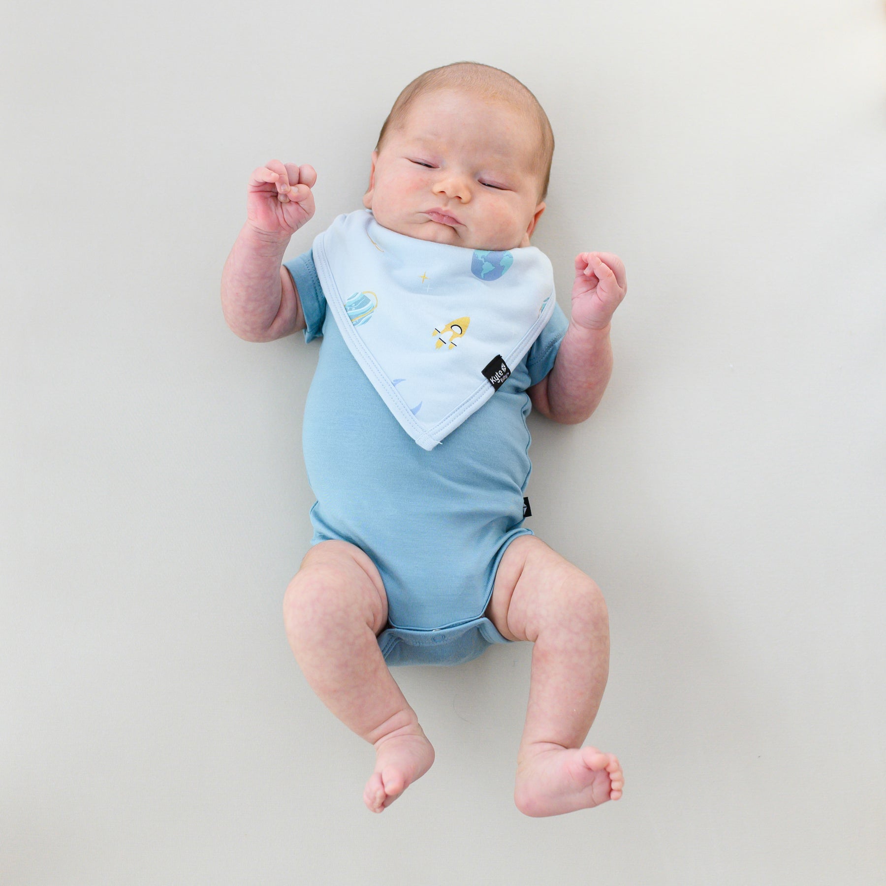 baby in slate bodysuit and ice space bib