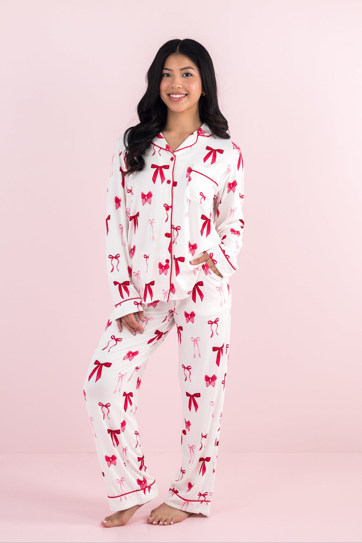 Smiling model wearing the Bamboo Long-Sleeved Women's Pajama Set in Big Love Bow