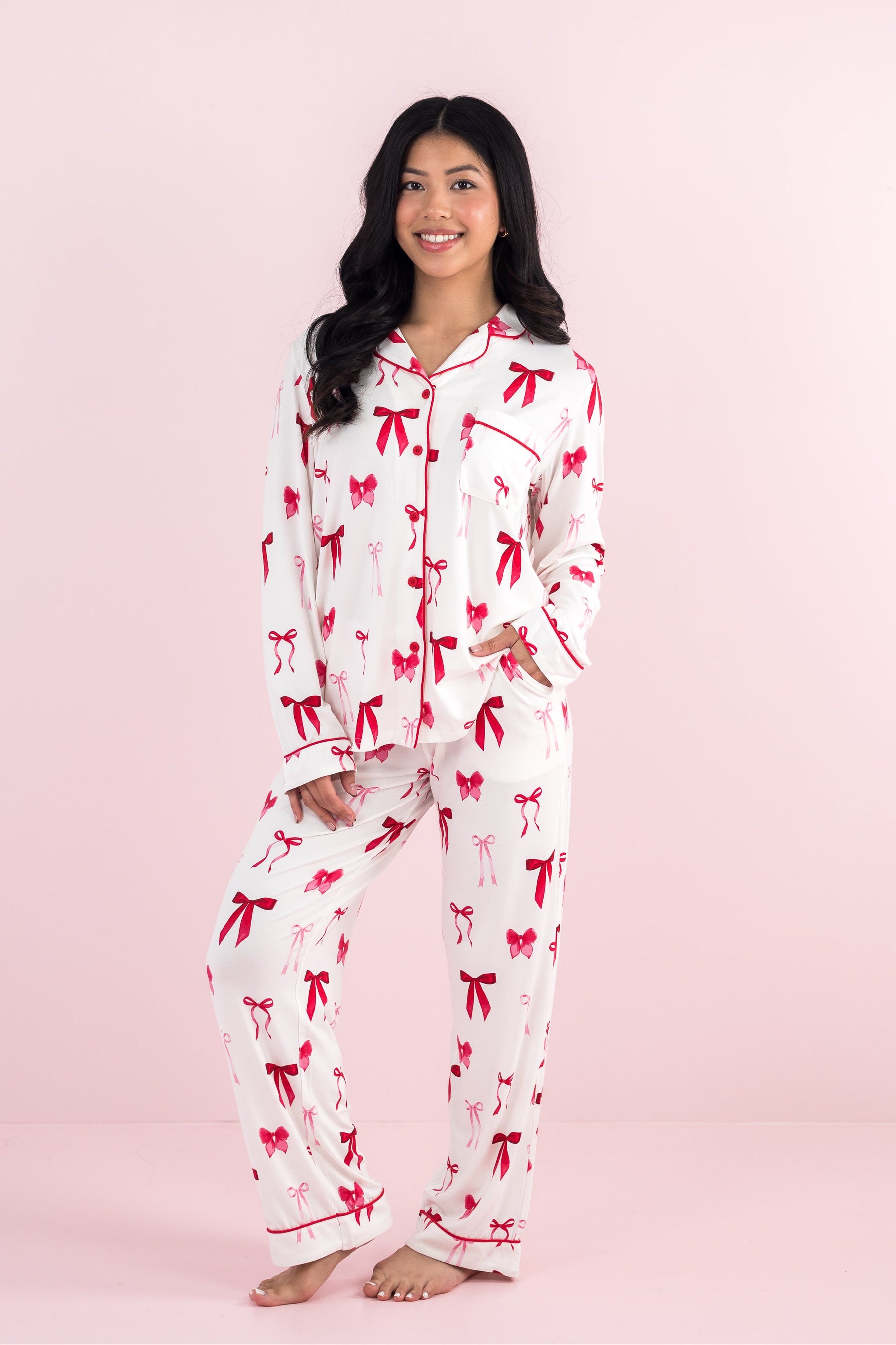 Smiling model wearing the Bamboo Long-Sleeved Women's Pajama Set in Big Love Bow