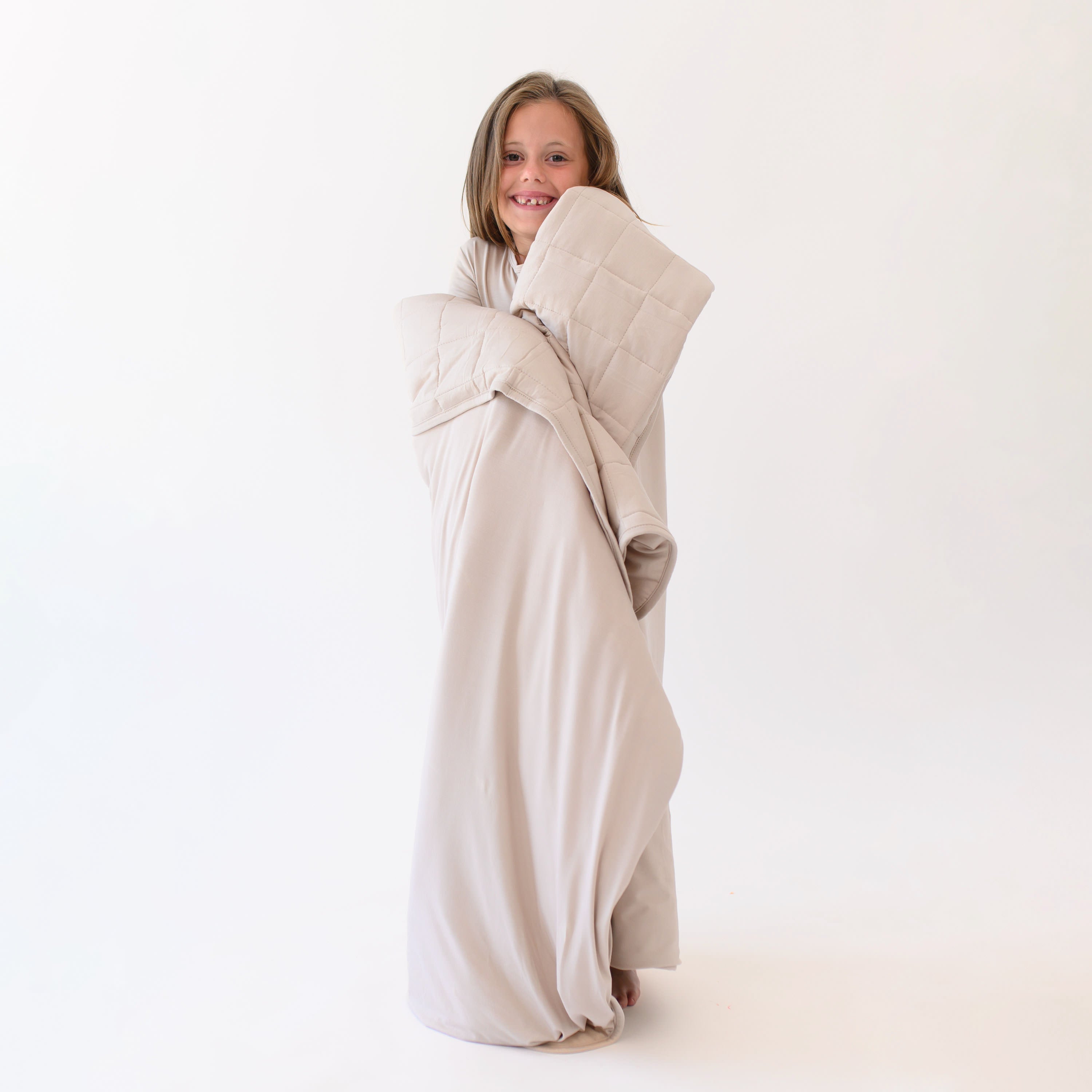 Smiling girl model standing wrapped in a Youth Blanket in Bisque 2.5